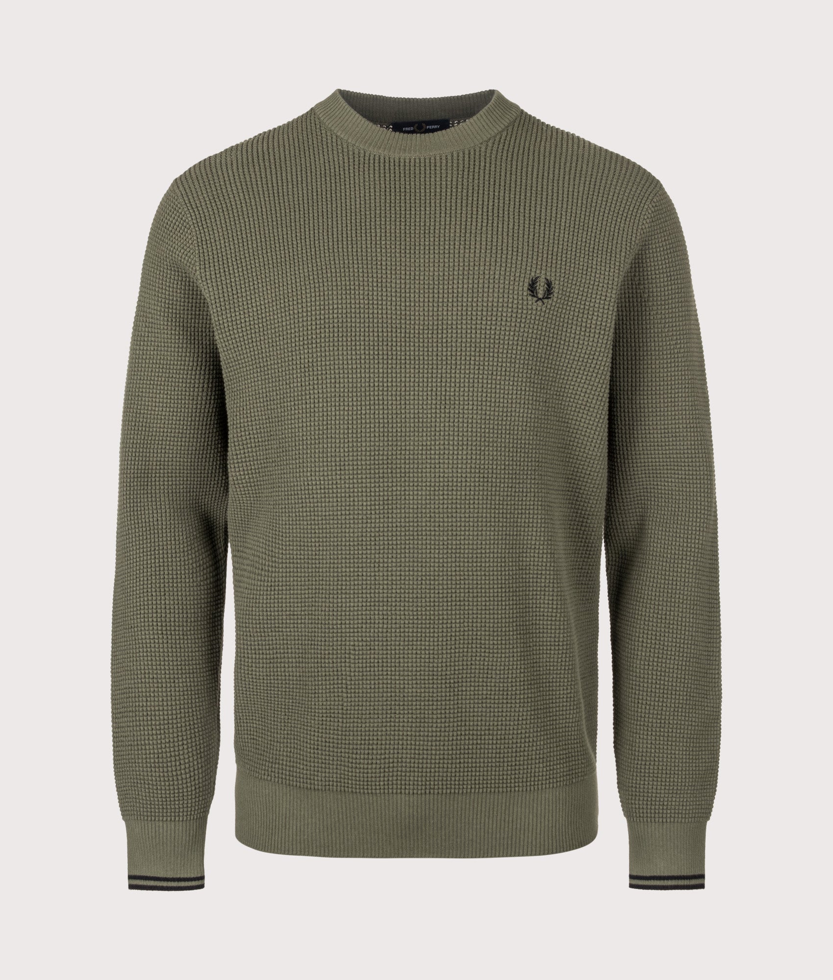 Fred Perry release the Regular Fit Waffle Stitch Jumper in Laurel Wreath Green at EQVVS Menswear. Front shot.