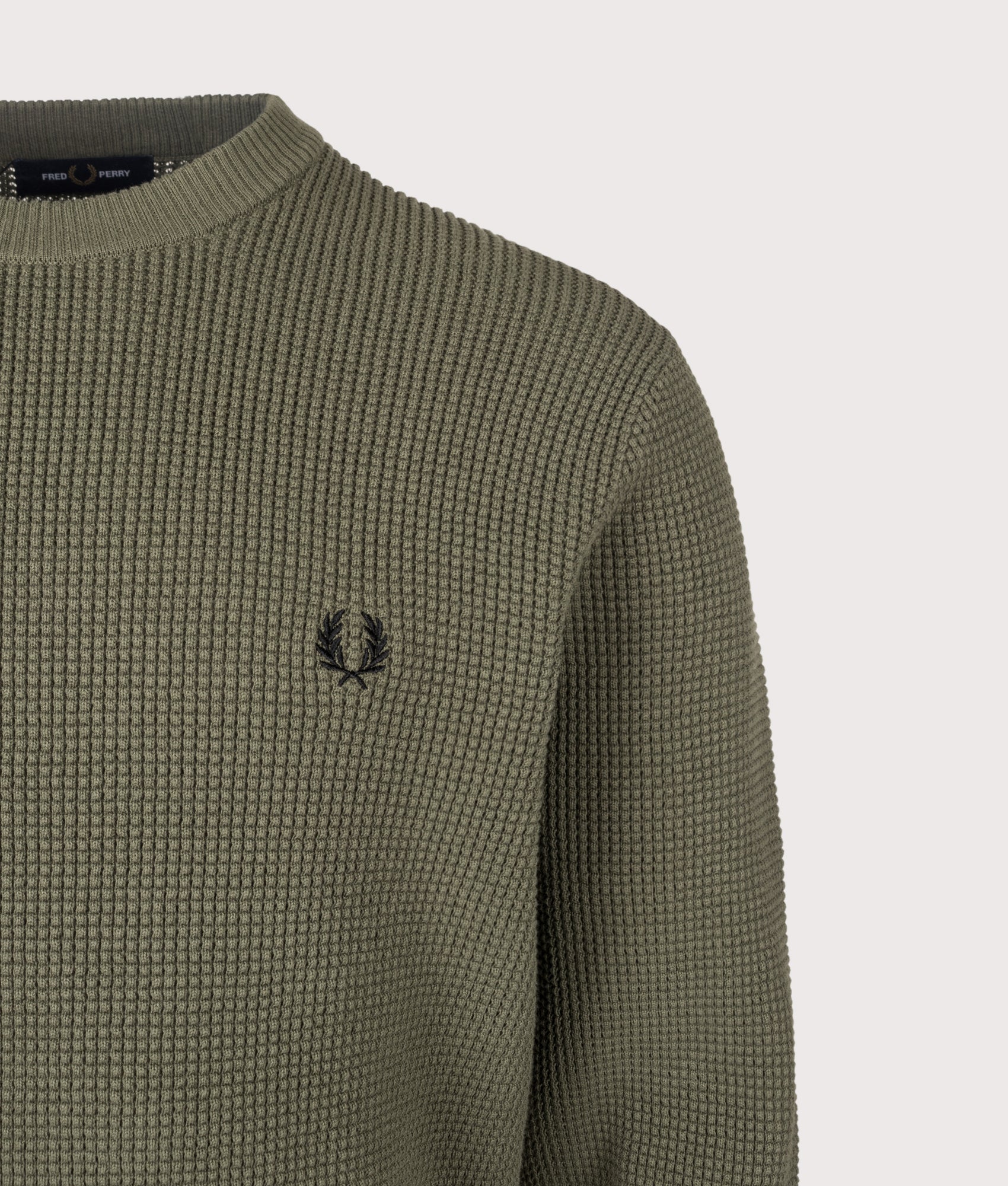 Fred Perry release the Regular Fit Waffle Stitch Jumper in Laurel Wreath Green at EQVVS Menswear. Detail shot.