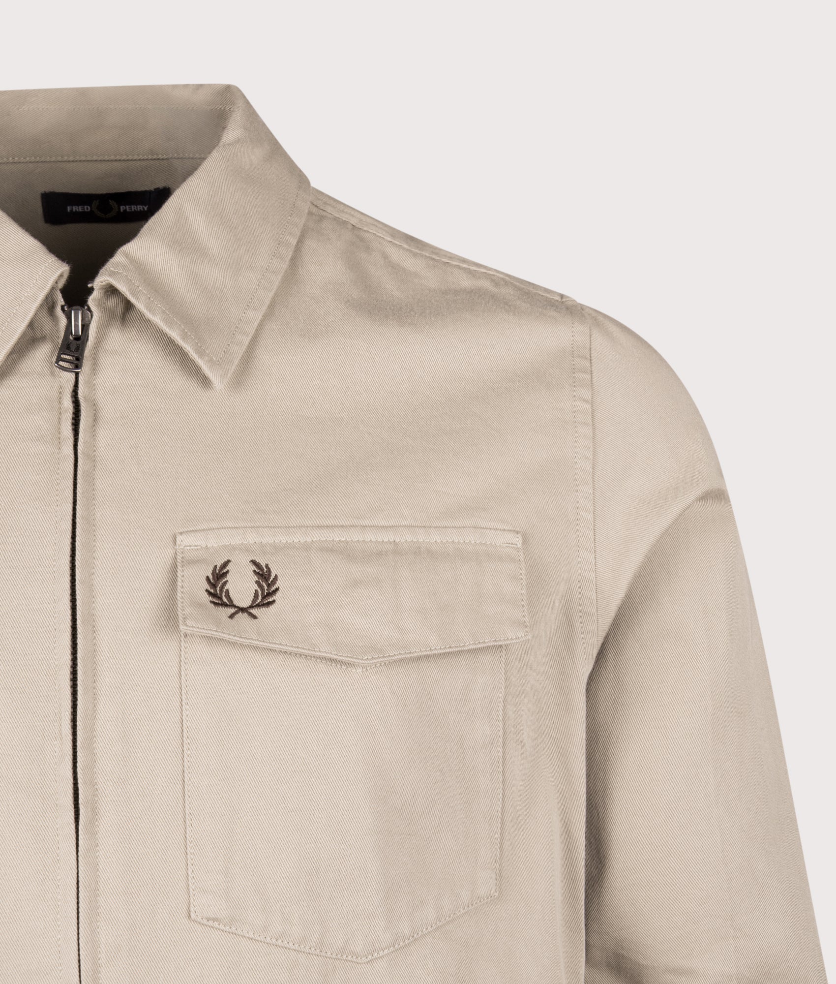 Fred Perry Twill Zip Through Overshirt in Warm Oat at EQVVS Menswear. Detail shot.