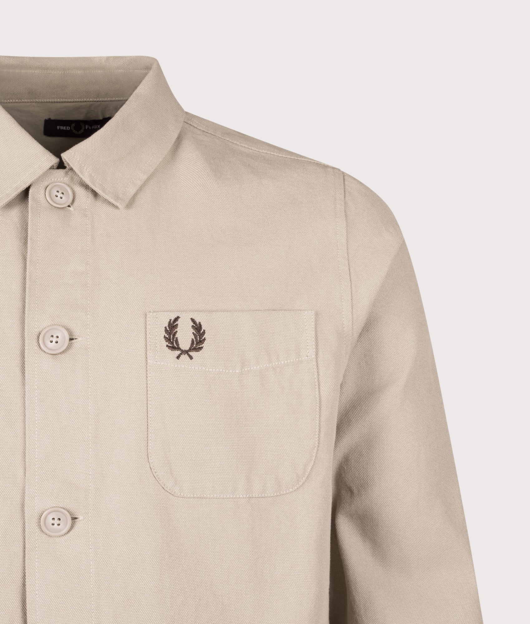 Fred Perry Canvas Overshirt in Warm Oat at EQVVS Menswear. Detail shot.