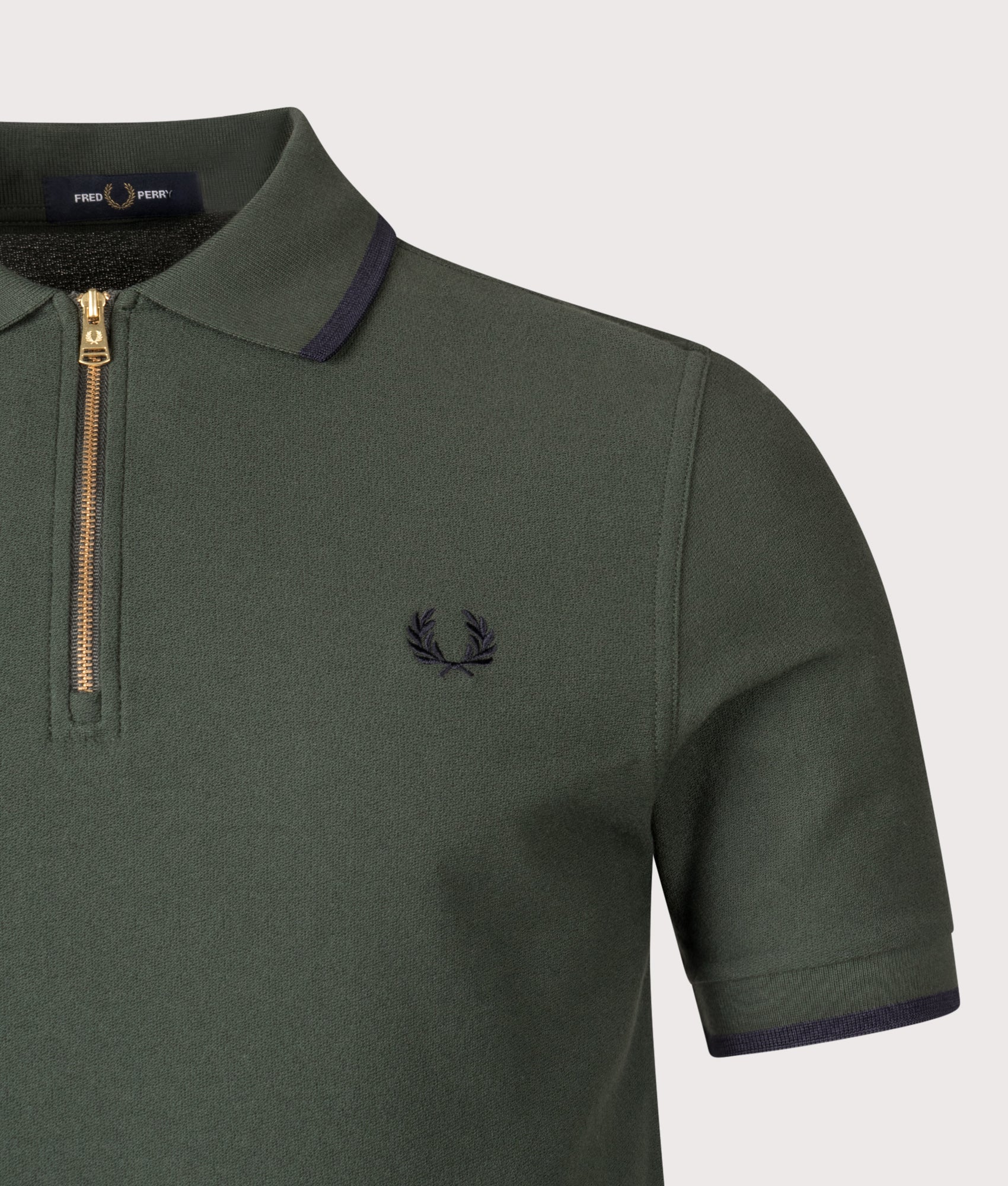 Fred Perry Crepe Piqué Polo Shirt in Court Green at EQVVS Menswear. Detail shot.