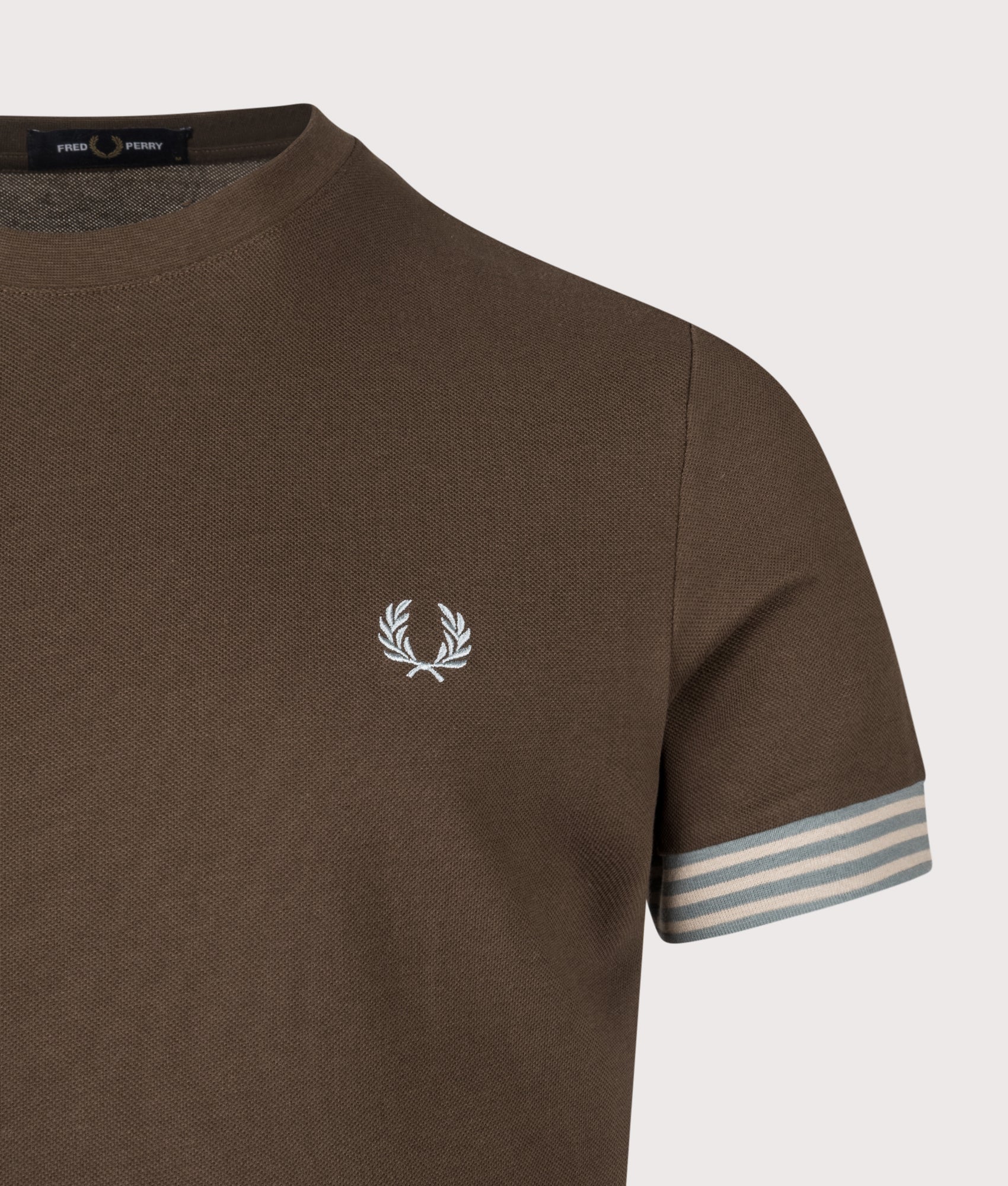 Fred Perry Striped Cuff T-Shirt in Burnt Tobacco at EQVVS Menswear. Detail shot.