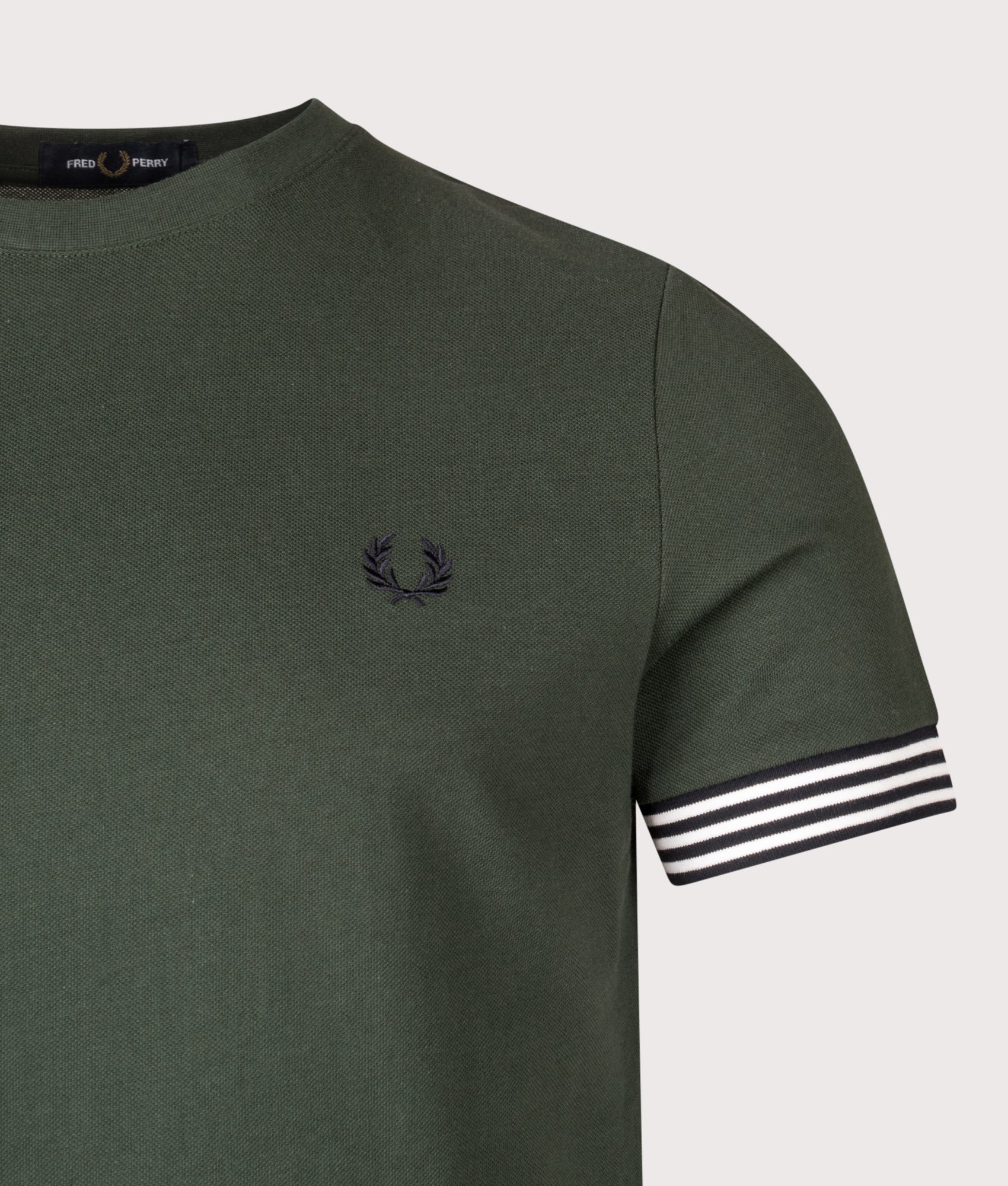 Fred Perry Striped Cuff T-Shirt in Court Green at EQVVS Menswear. Detail shot.