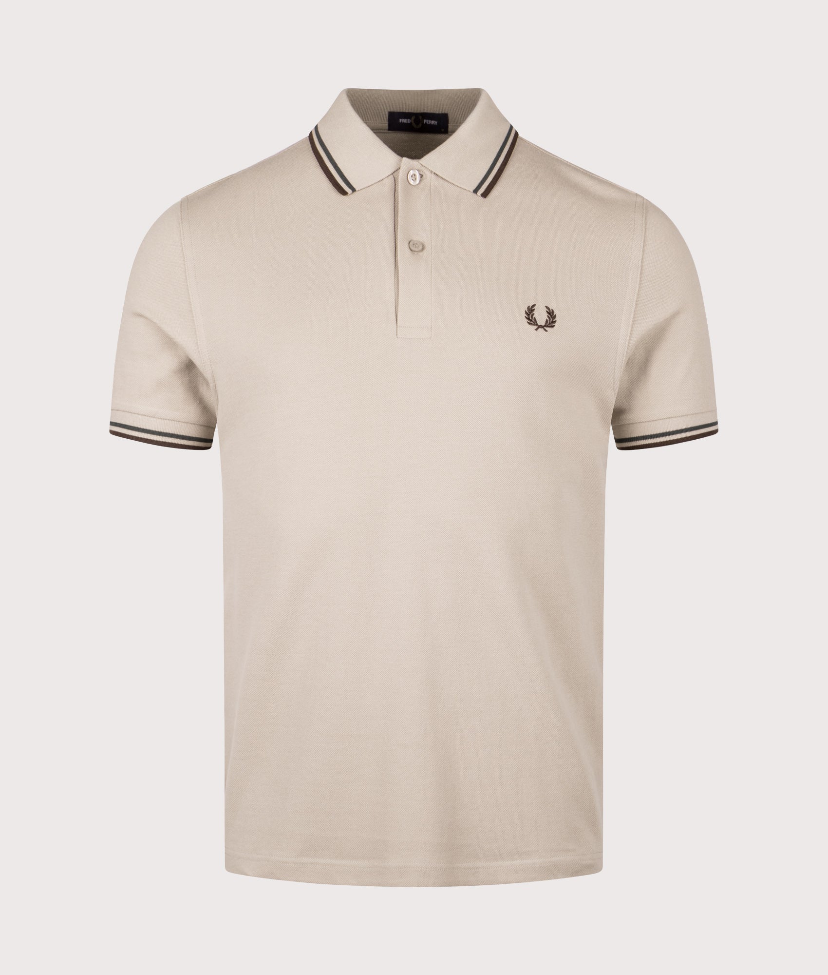 Fred Perry Twin Tipped Polo Shirt in Warm Oat, Court Green and Burnt Tobacco at EQVVS Menswear. Front shot.