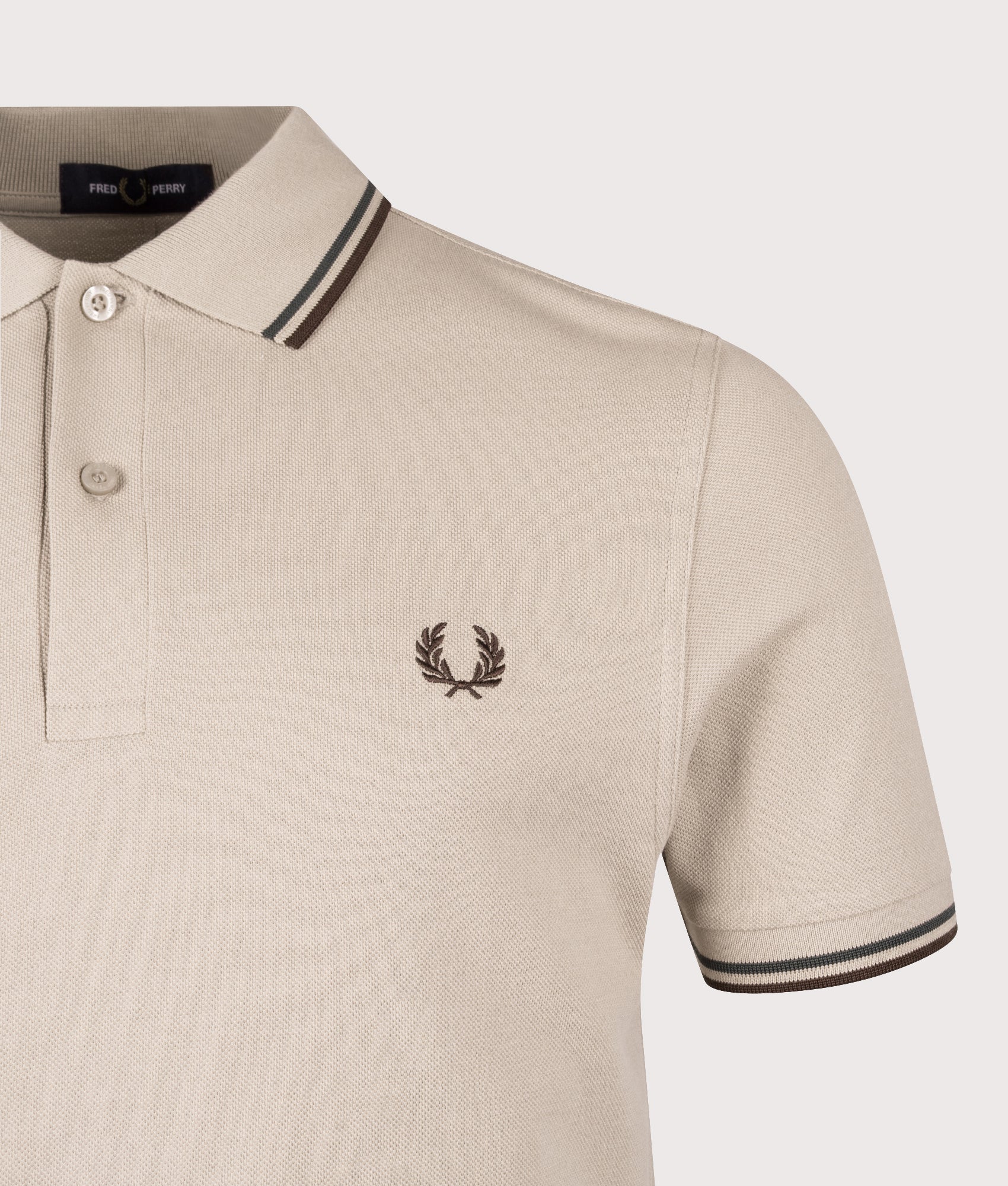 Fred Perry Twin Tipped Polo Shirt in Warm Oat, Court Green and Burnt Tobacco at EQVVS Menswear. Detail shot.