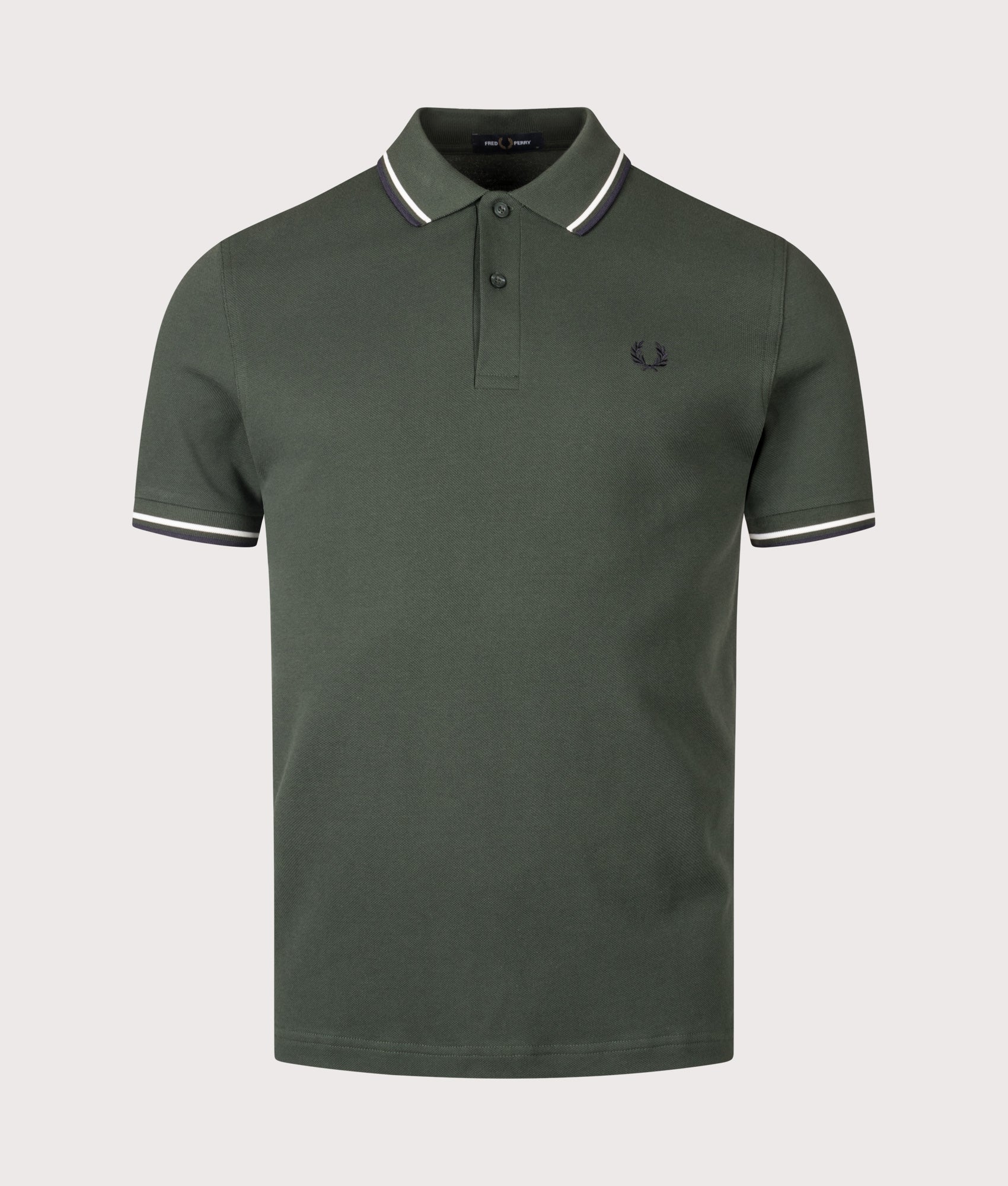 Fred Perry Twin Tipped Fred Perry Polo Shirt in Court Green, Snow White and Navy at EQVVS Menswear. Front shot.