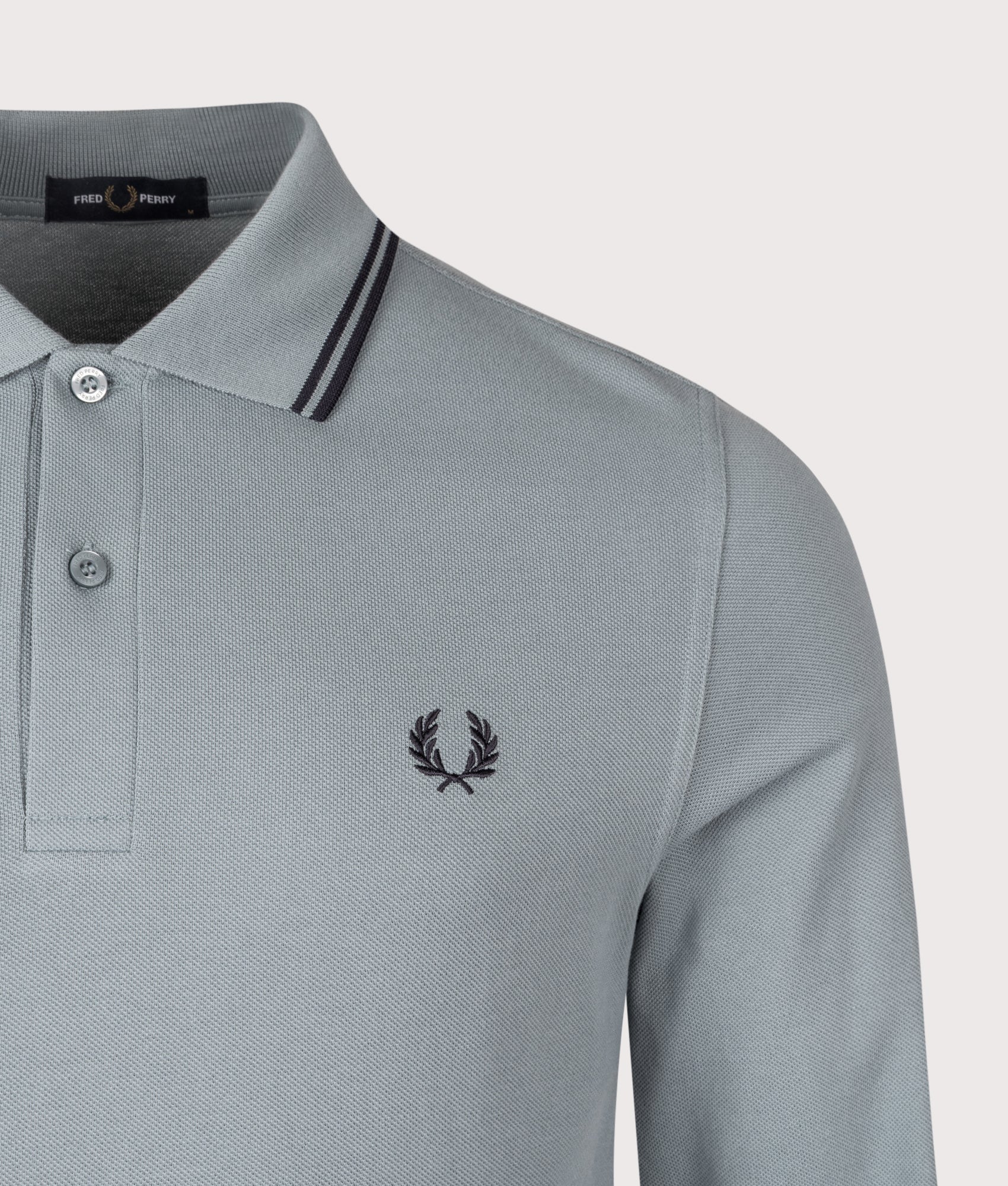 Fred Perry Long Sleeve Twin Tipped Polo Shirt in Stockport Blue and Navy at EQVVS Menswear. Detail shot.