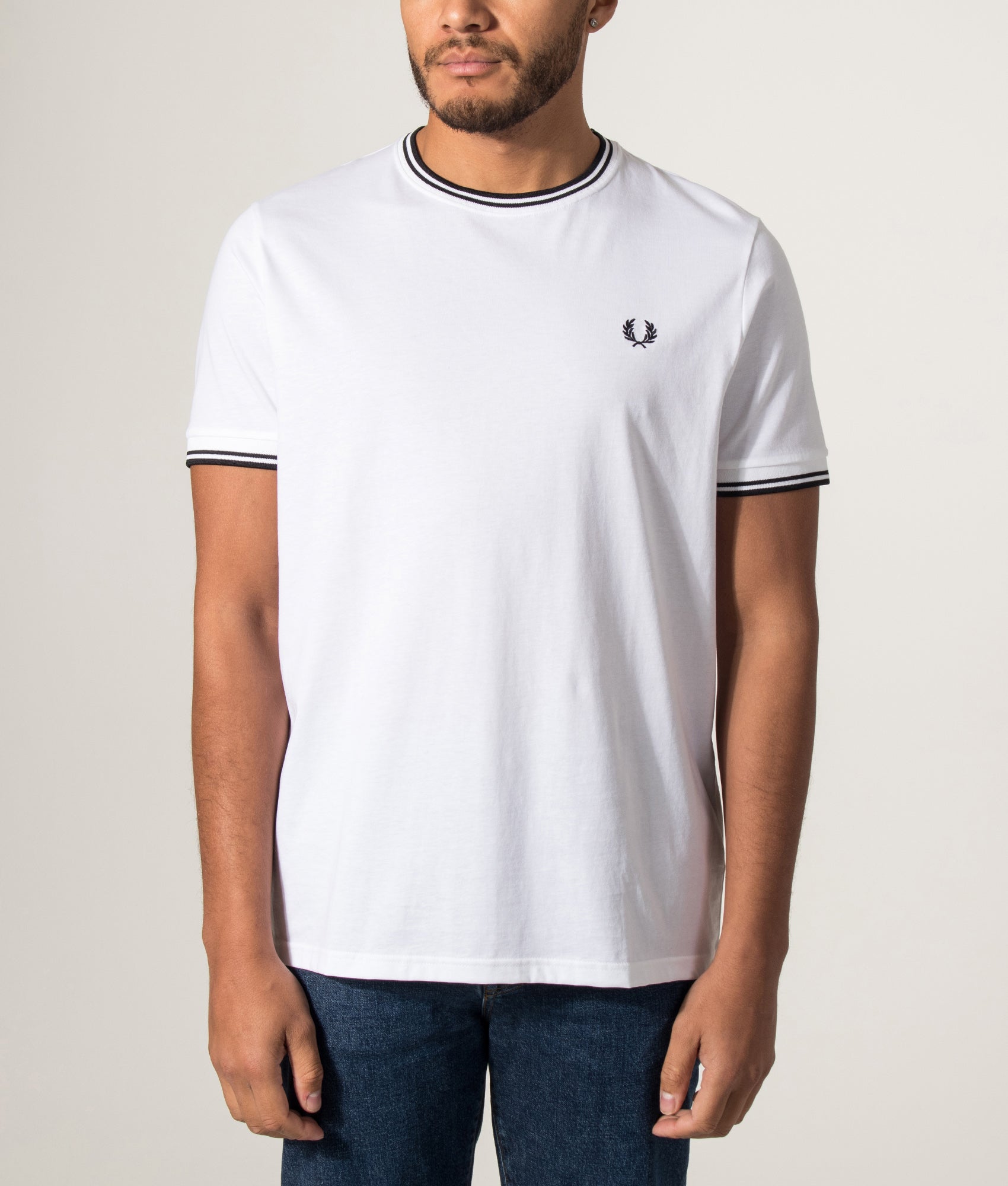 Fred Perry Twin Tipped T-Shirt in White at EQVVS Menswear. Model front shot.