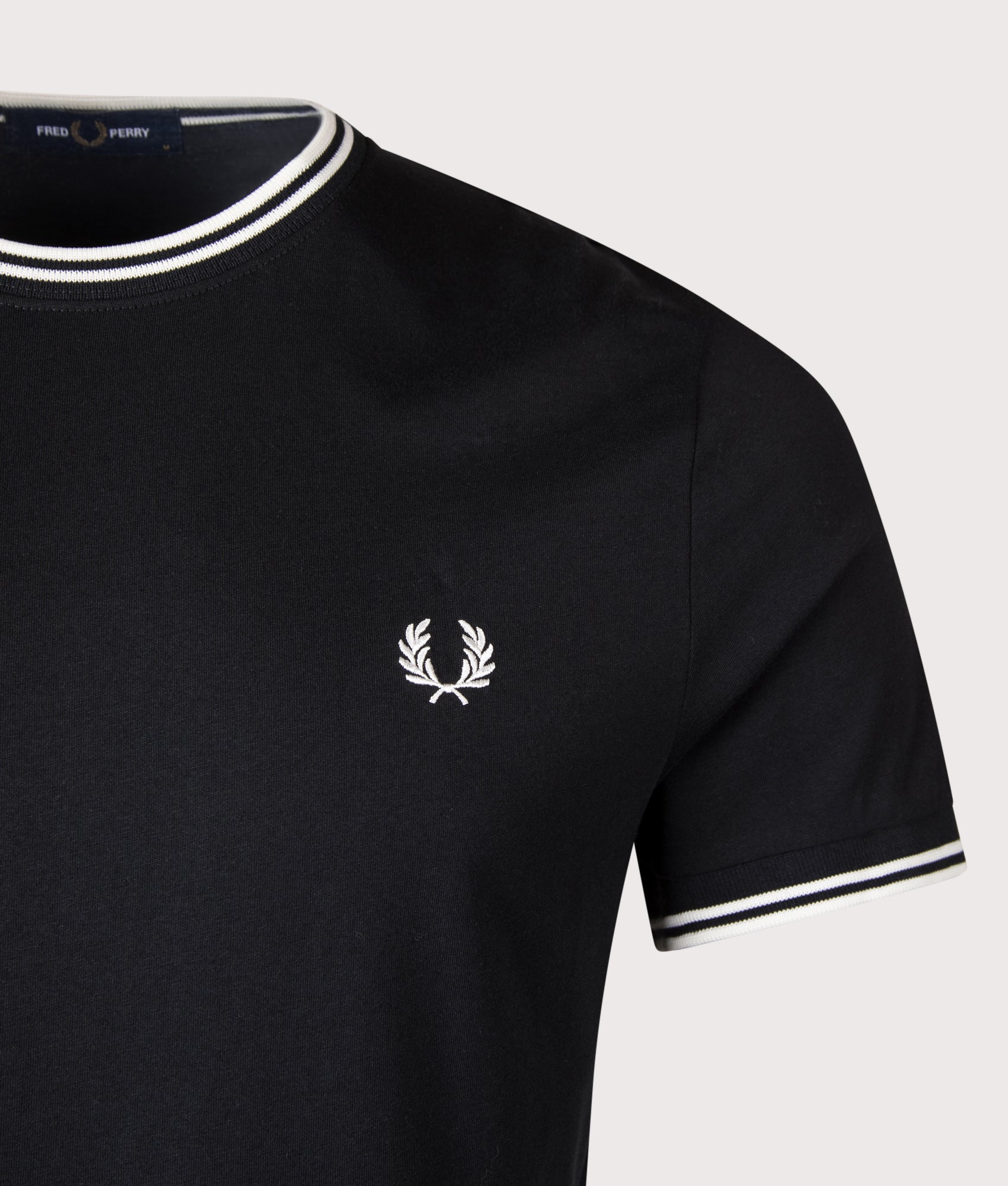 Twin Tipped T-Shirt in Black by Fred Perry. Detail shot. Shot By EQVVS.