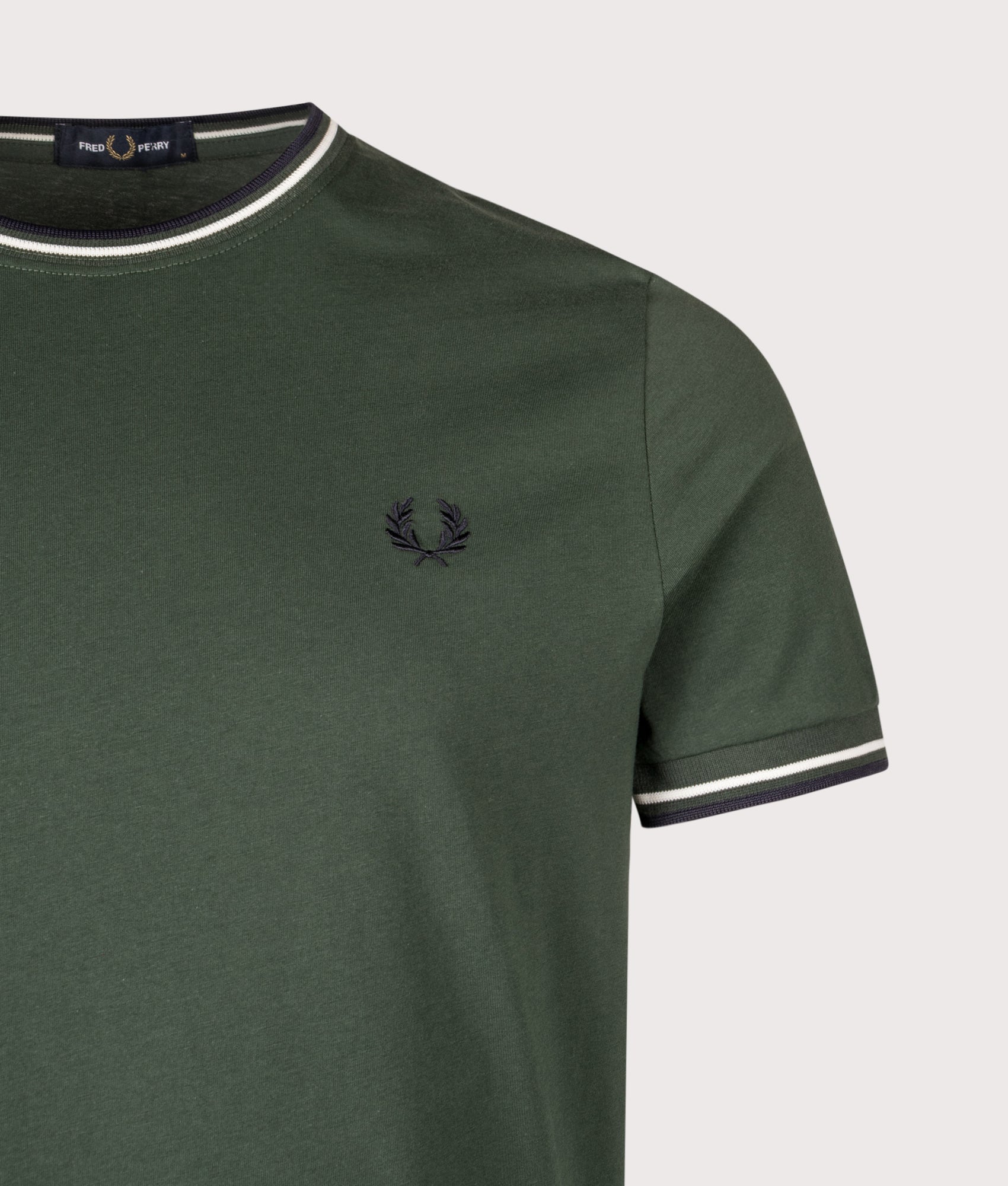 Fred Perry Twin Tipped T-Shirt in Court Green, Snow White and Navy at EQVVS Menswear. Detail shot. 