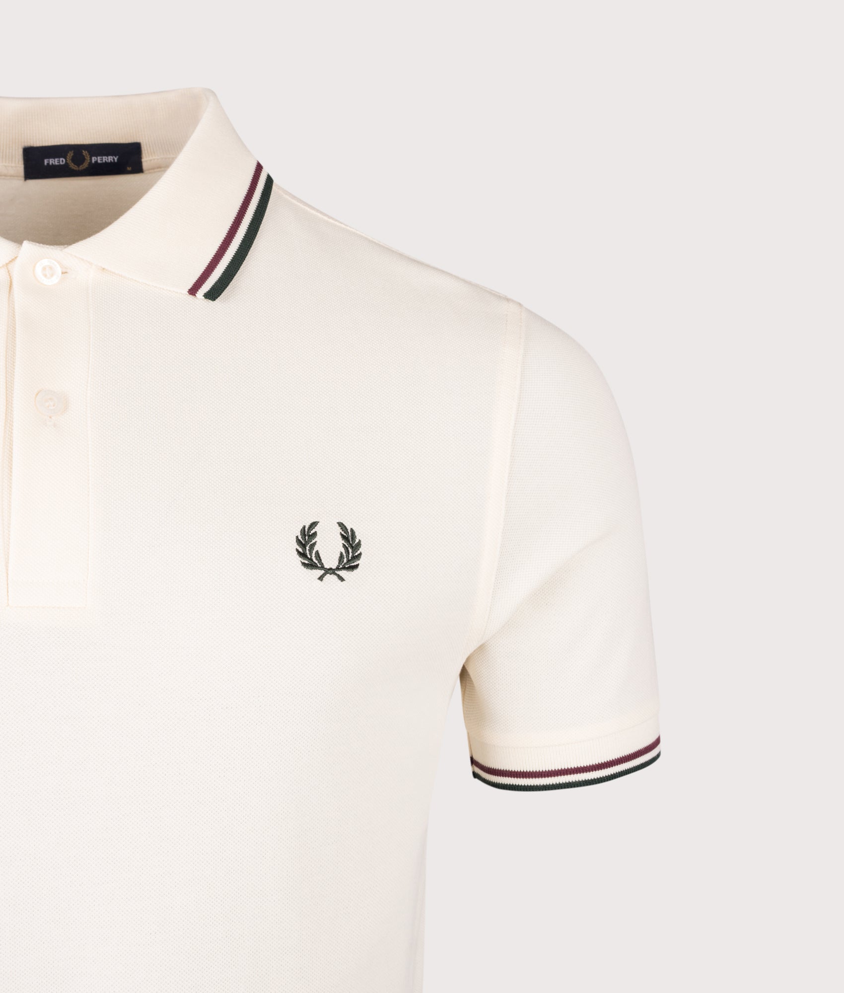 Fred Perry Twin Tipped Fred Perry Polo Shirt in Ecru, Oxblood and Grassroots at EQVVS Menswear. Detail shot.