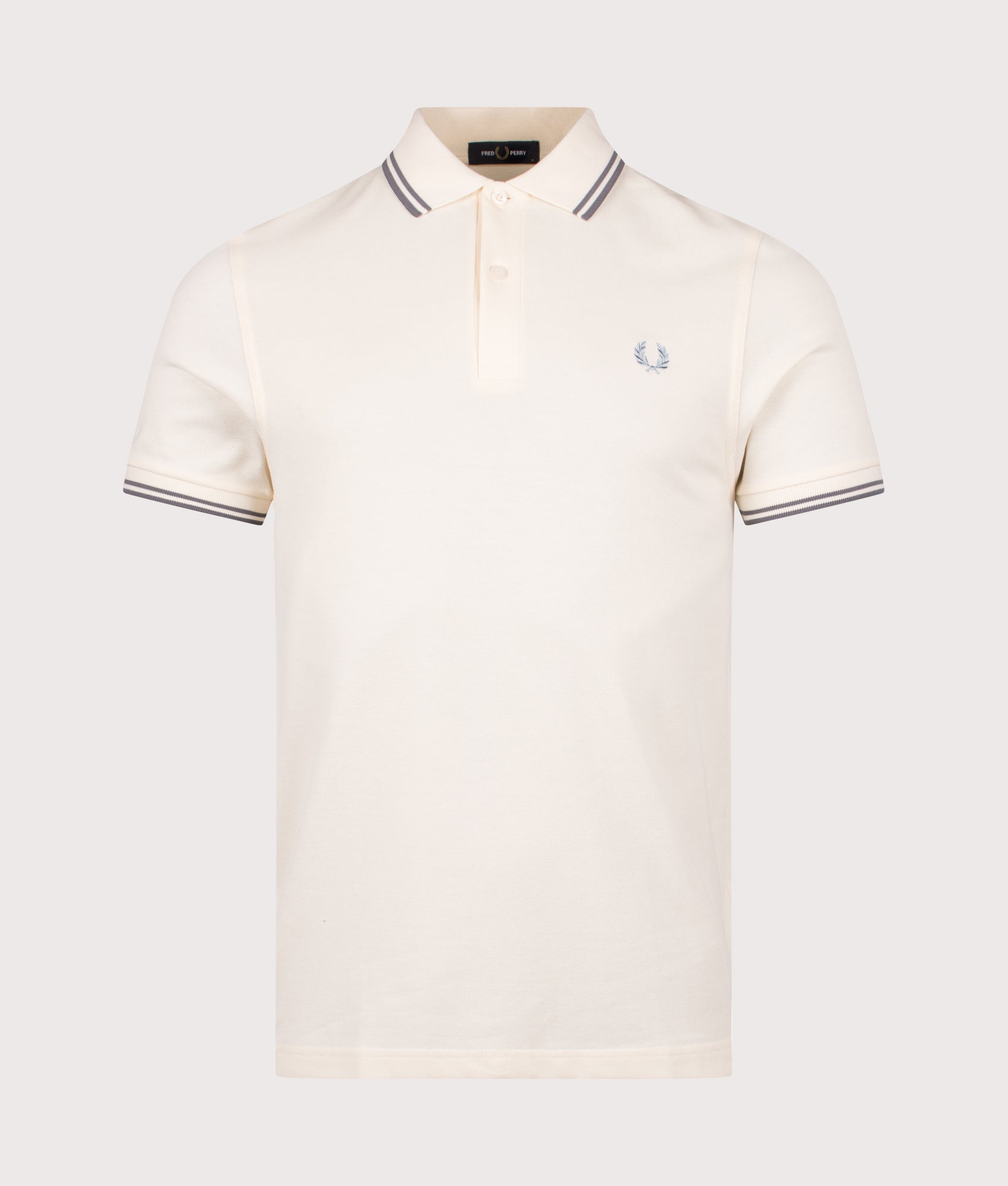 Fred Perry Twin Tipped Polo Shirt in Ecru and Stockport Blue at EQVVS Menswear. Front shot.