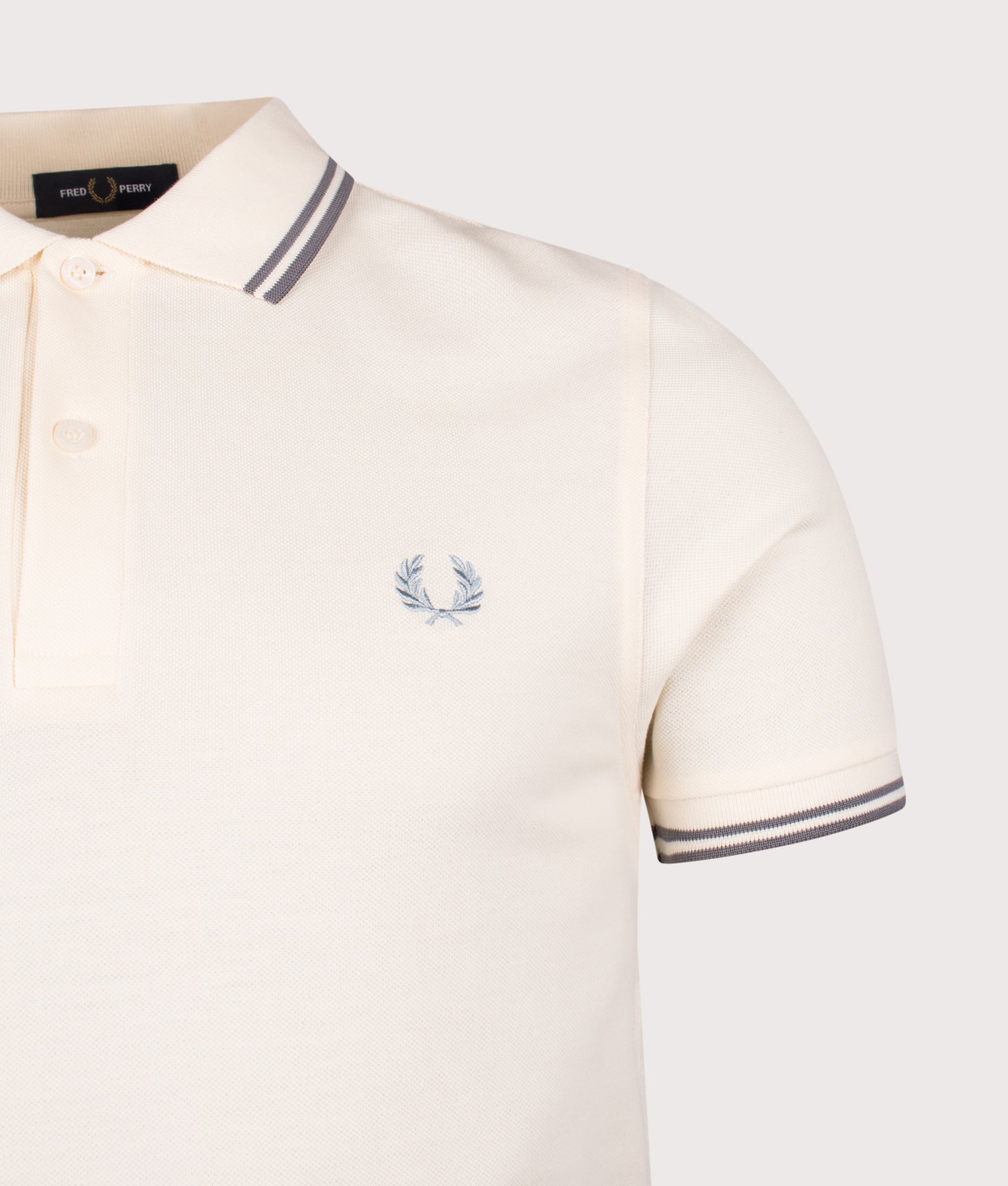 Fred Perry Twin Tipped Polo Shirt in Ecru and Stockport Blue at EQVVS Menswear. Detail shot.