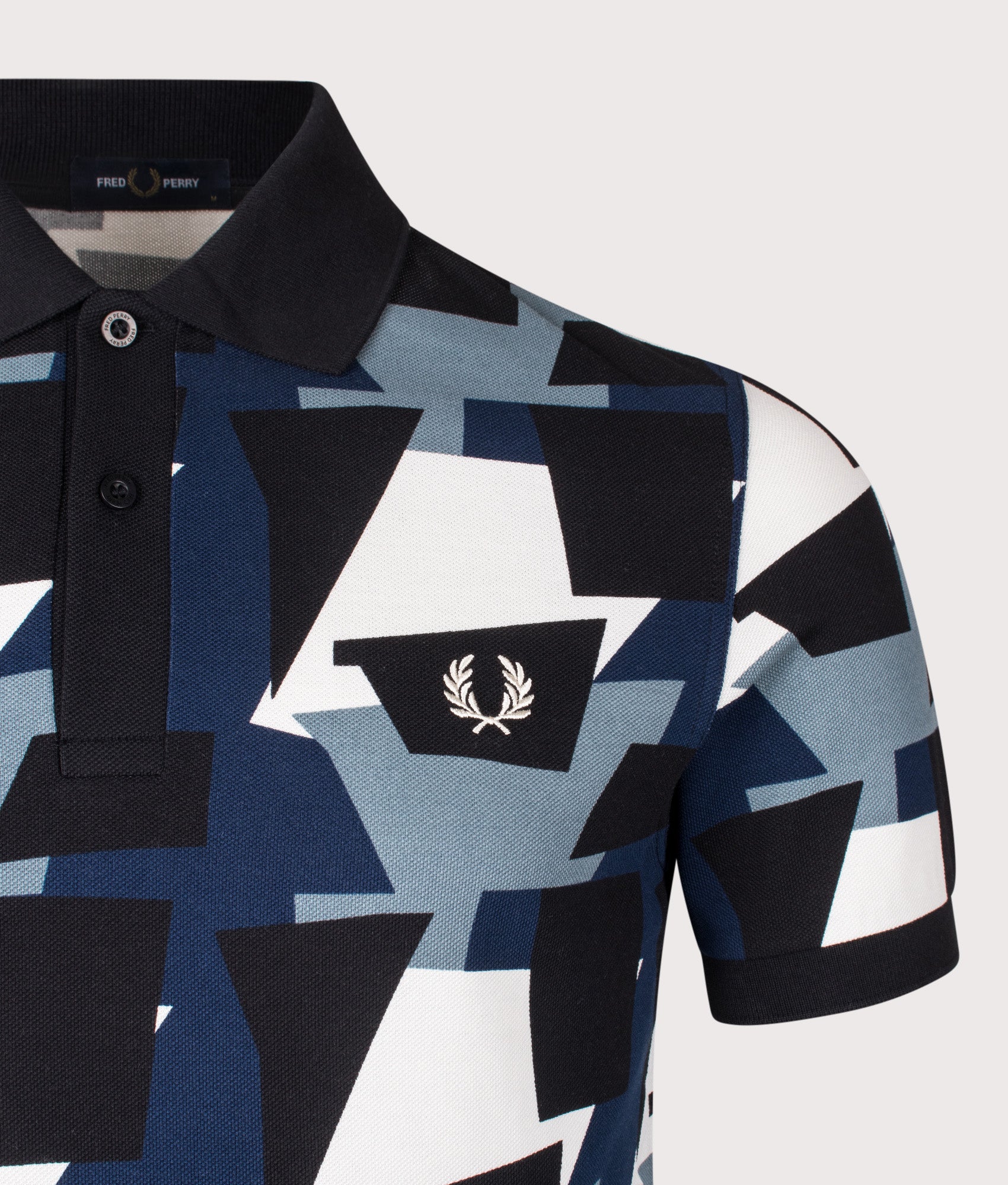 Fred Perry Fragment Print Polo Shirt in Ecru at EQVVS Menswear. Detail shot.