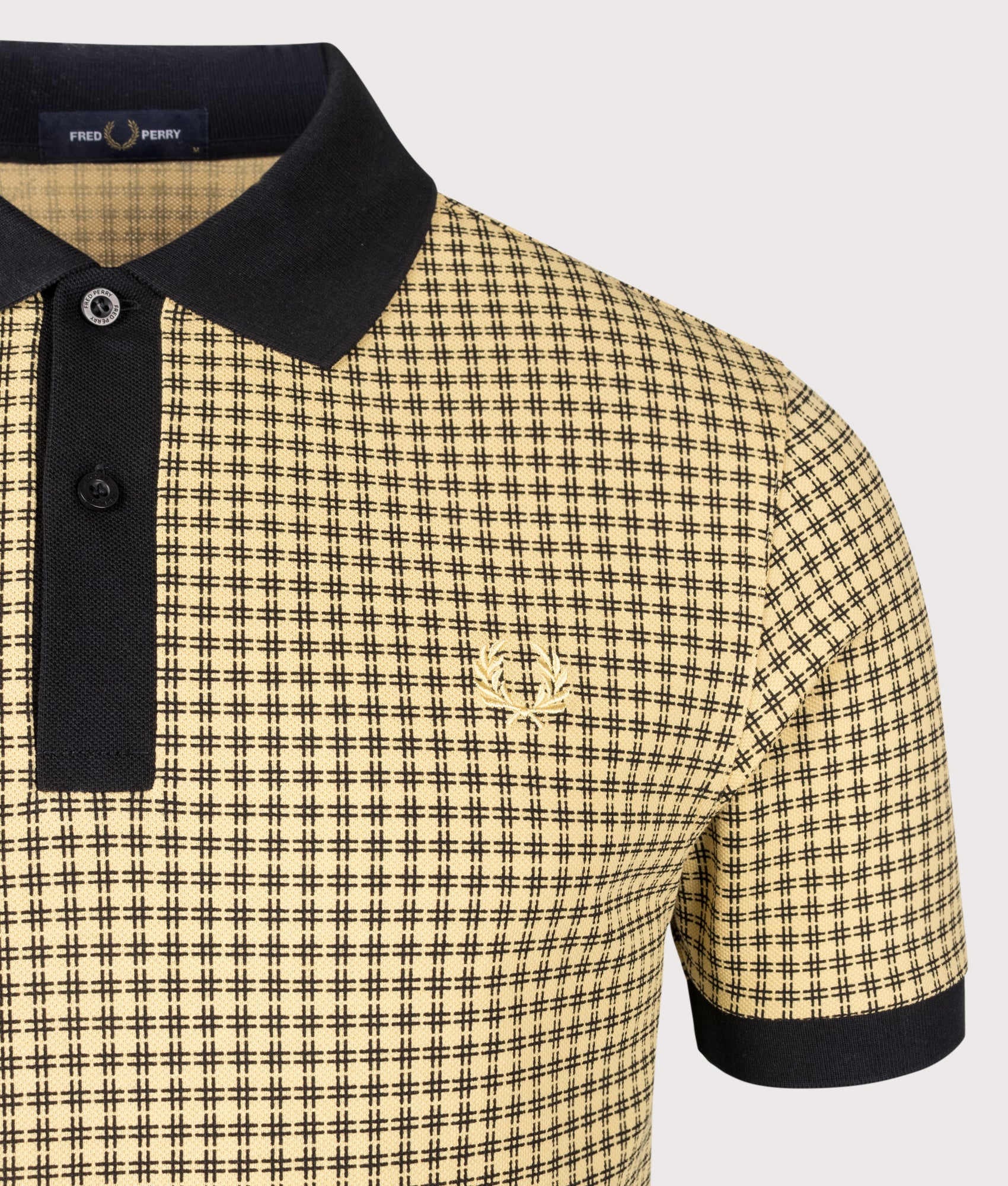 Fred Perry Cross Print Polo Shirt in Black at EQVVS Menswear. Detail shot.