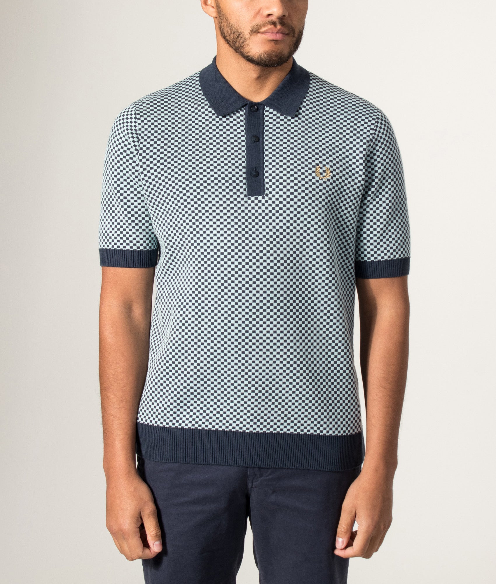 Fred Perry Chequerboard Knitted Polo Shirt in Dark Airforce at EQVVS Menswear. Model front shot.