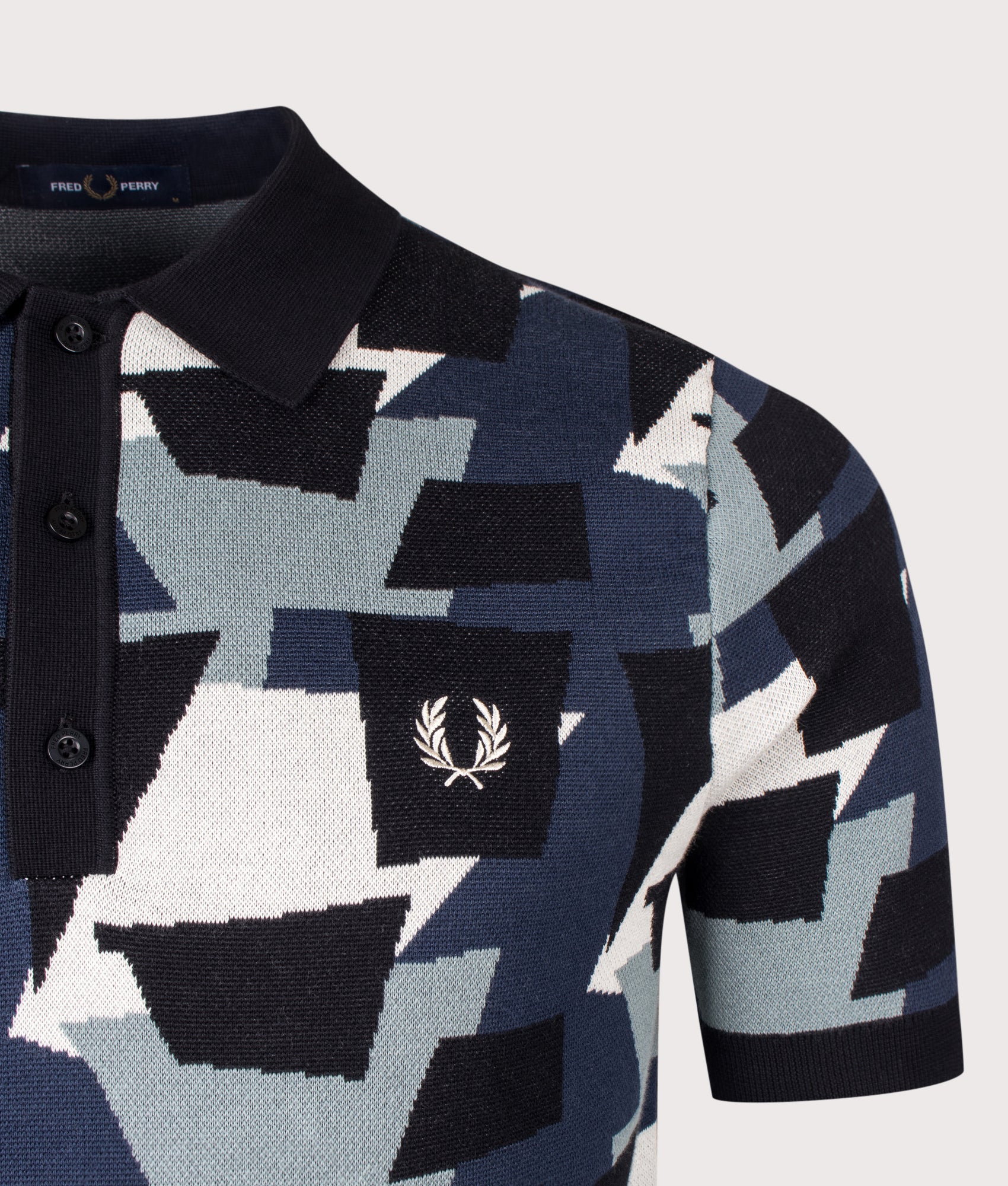 Fred Perry Fragment Jacquard Knit Polo Shirt in Black at EQVVS Menswear. Detail shot.
