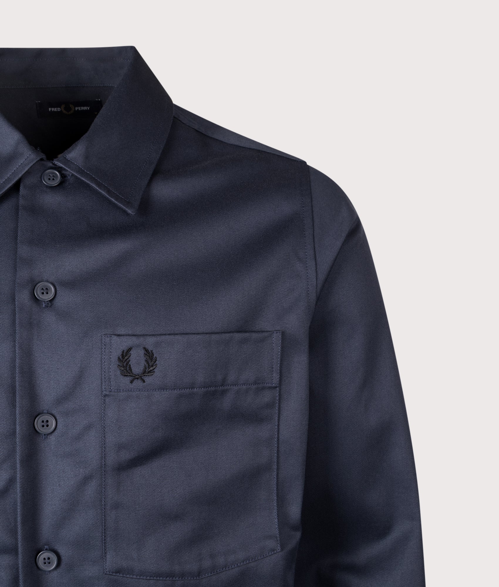 Fred Perry Twill Overshirt in Dark Airforce at EQVVS Menswear. Detail shot.