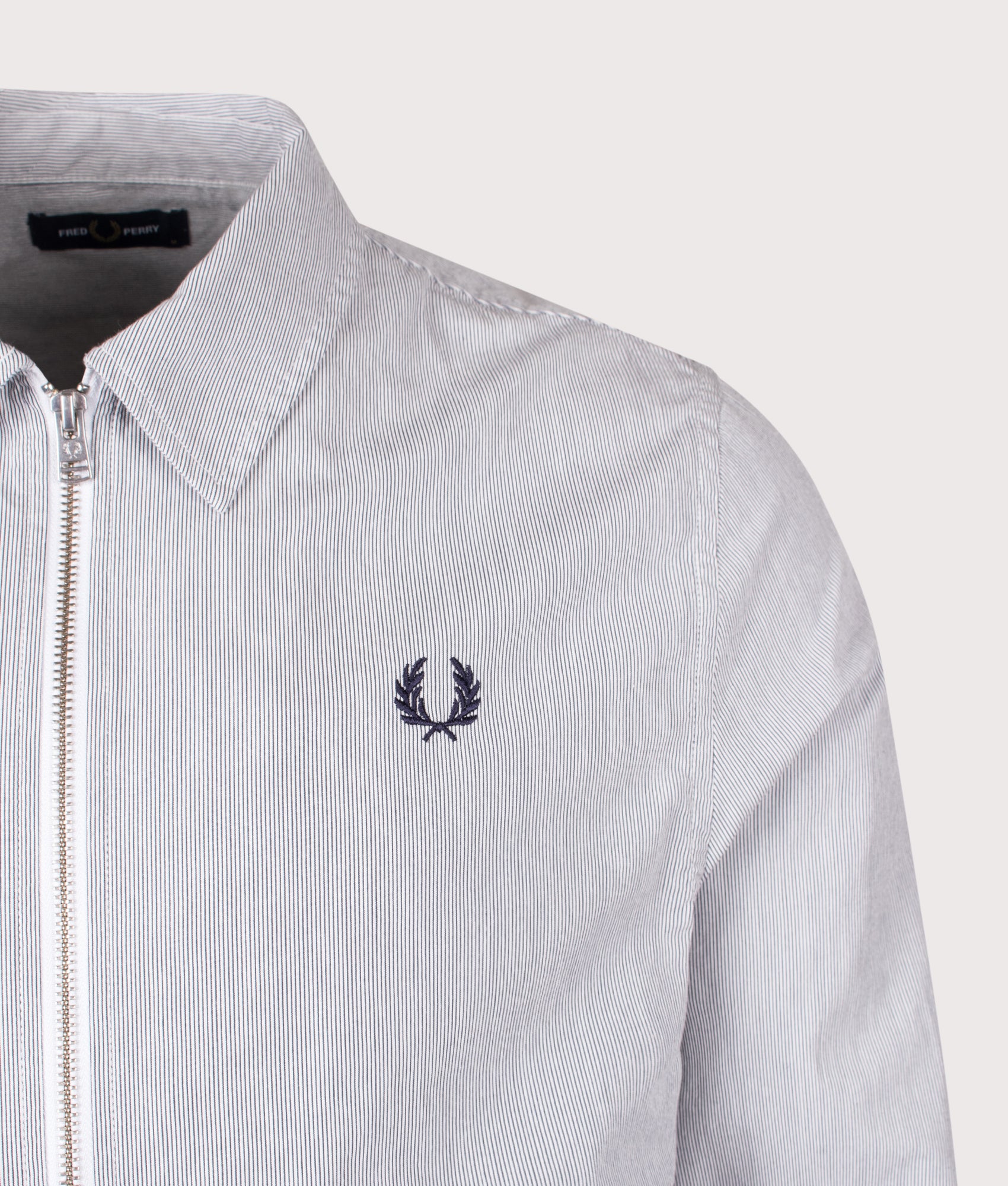 Fred Perry Striped Seersucker Zip Through Overshirt in Blue and White at EQVVS Menswear. Detail shot.
