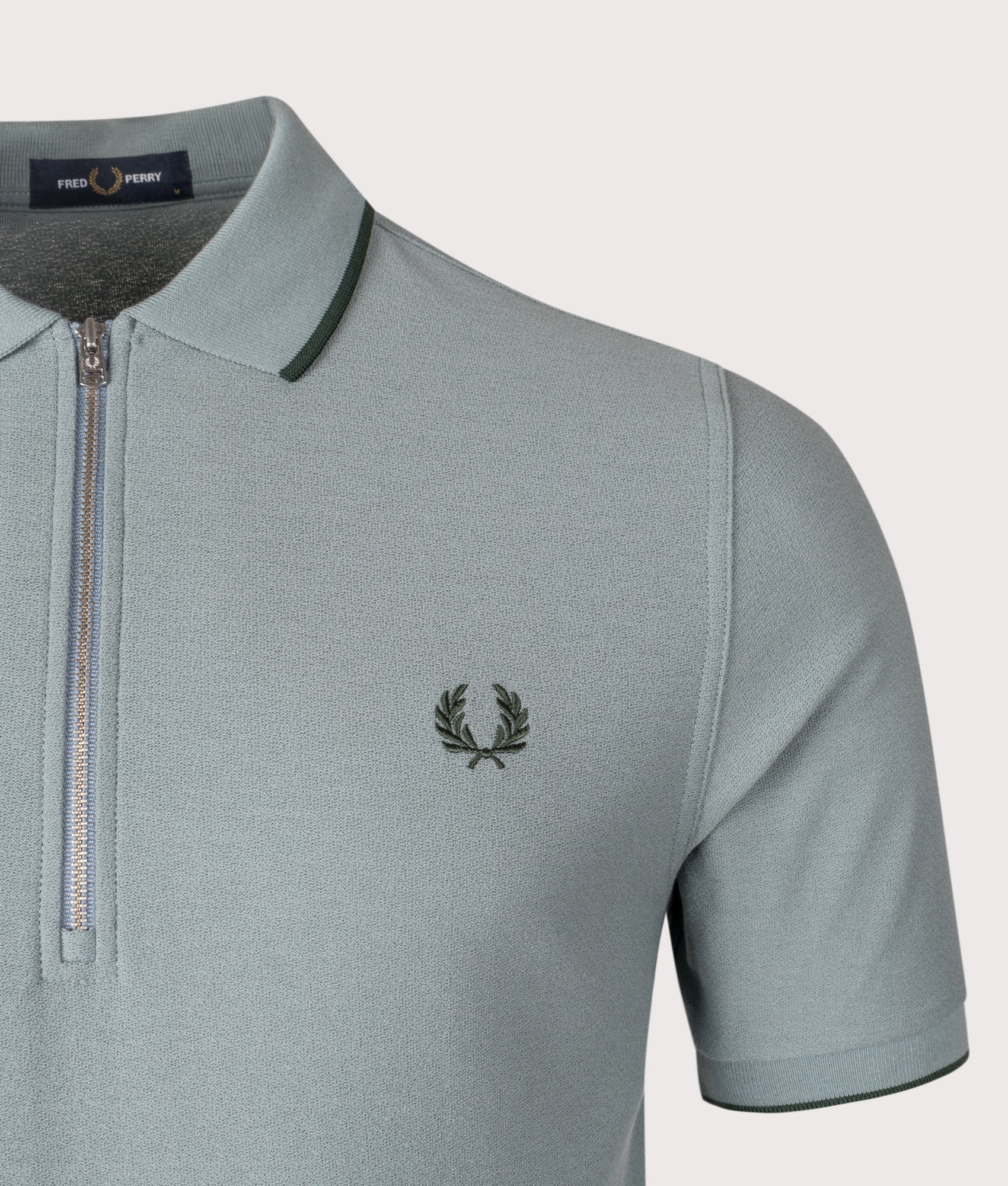 Fred Perry Crepe Piqué Polo Shirt in Stockport Blue at EQVVS Menswear. Detail shot.