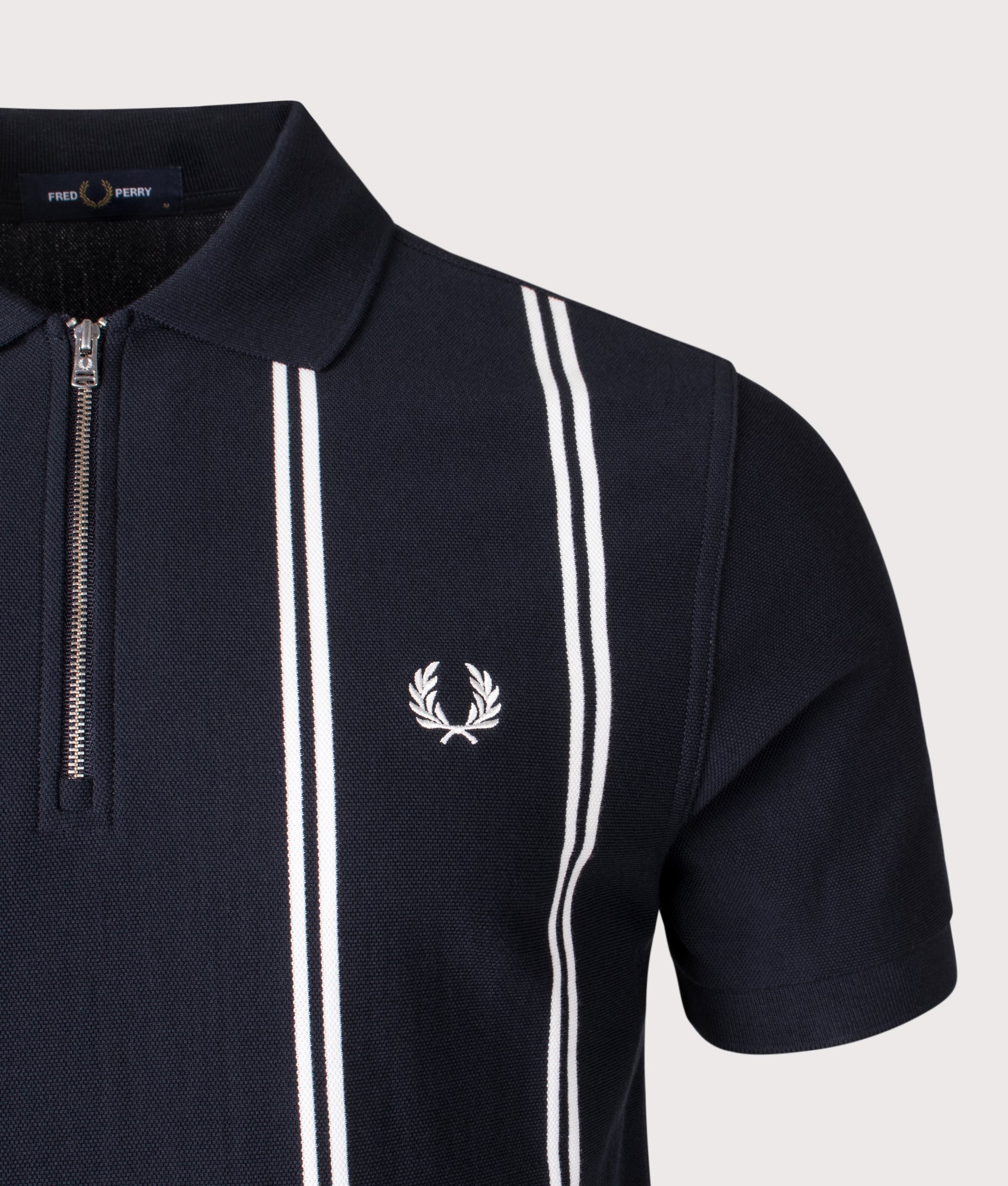 Fred Perry Vertical Stripe Zip Neck Polo Shirt in Navy at EQVVS Menswear. Detail shot.