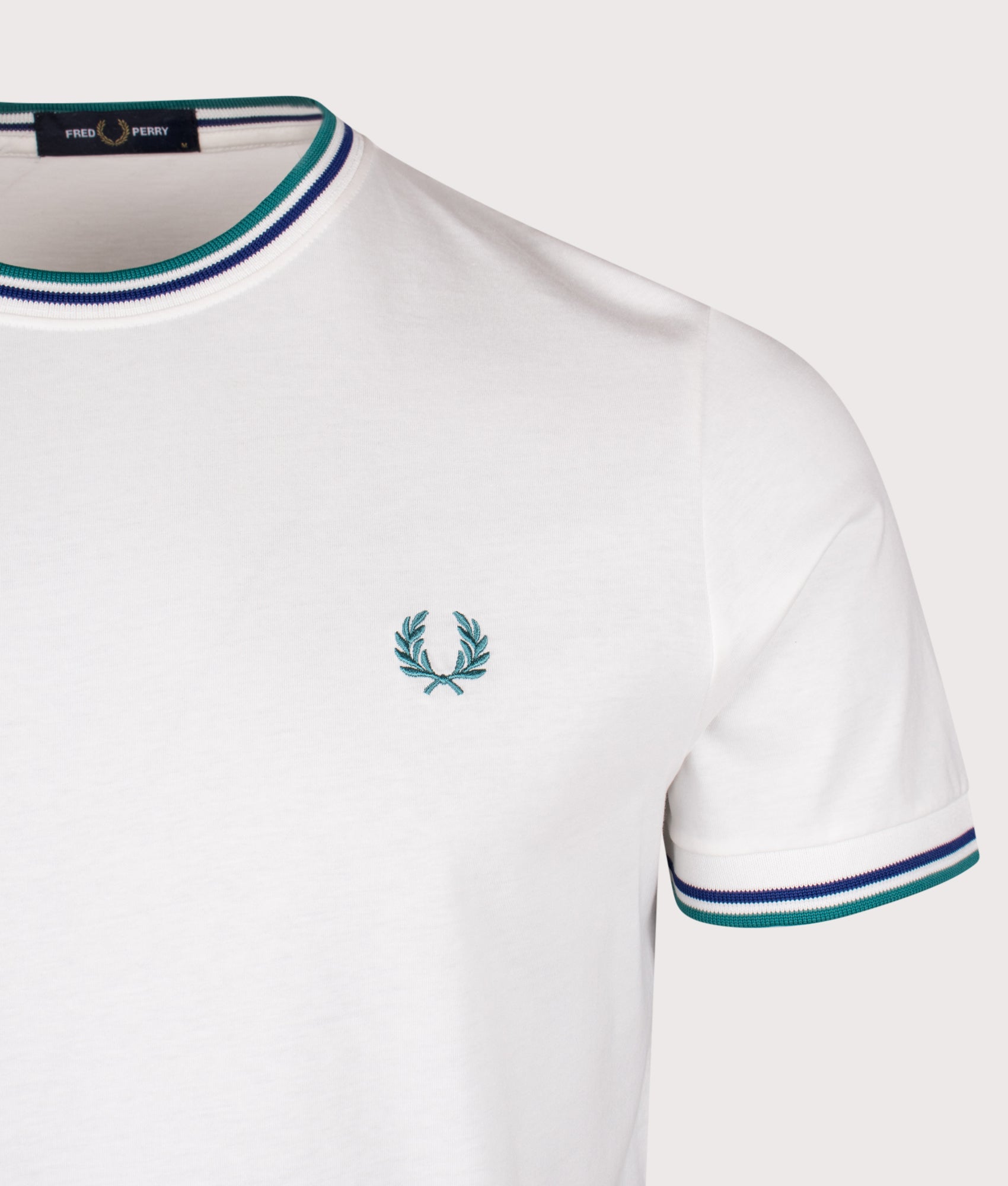 Fred Perry Twin Tipped T-shirt in Snow White, Deep Mint and Soho Eclipse at EQVVS Menswear. Detail shot.