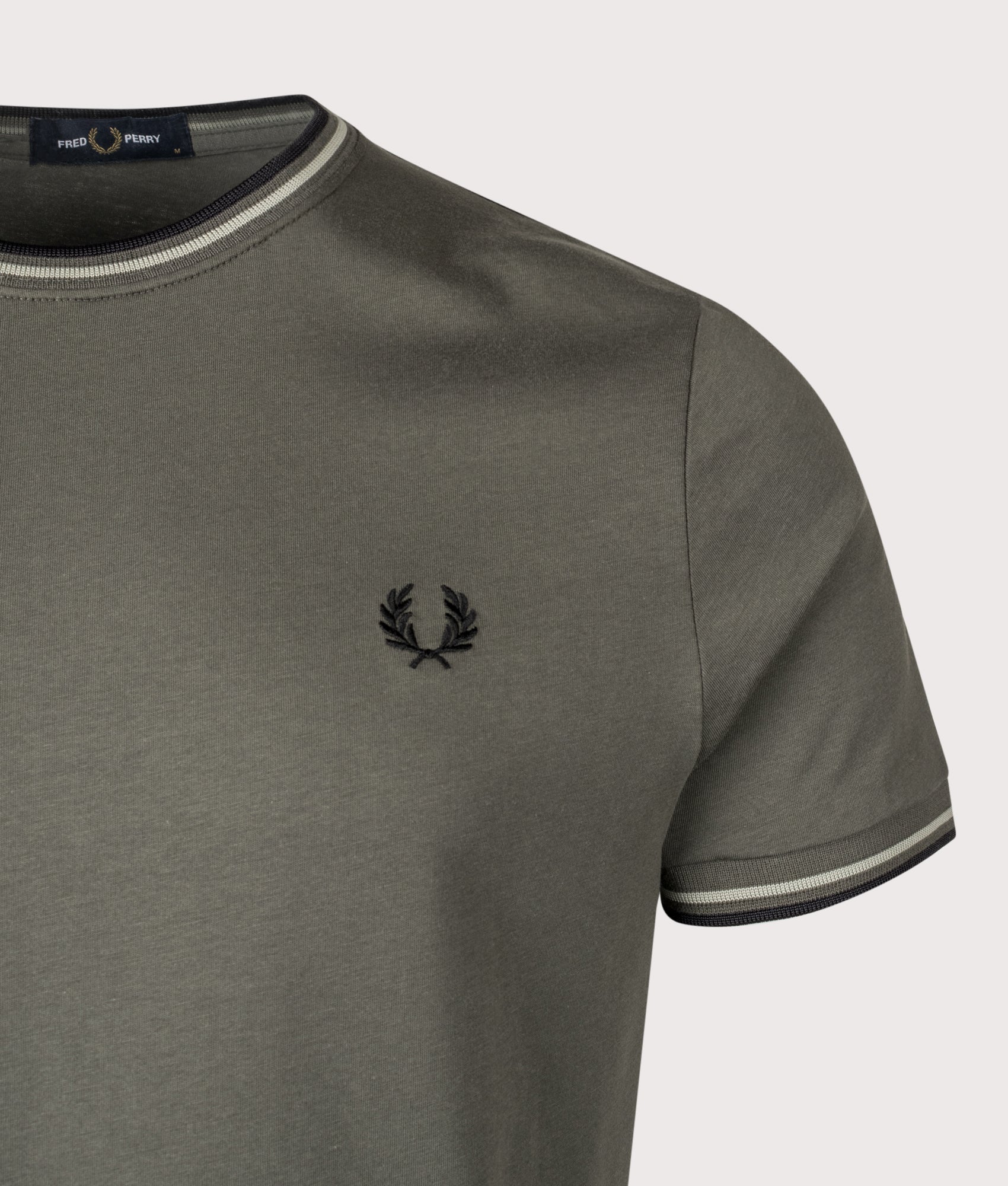 Fred Perry Twin Tipped T-Shirt in Field Green, Seagrass and Black at EQVVS Menswear. Detail shot.