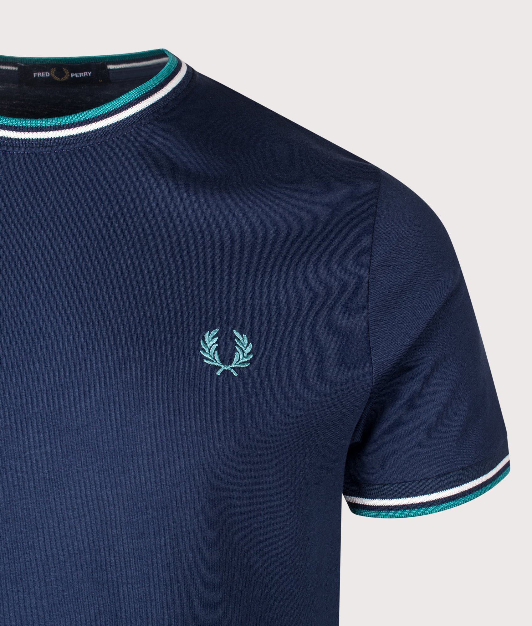 Fred Perry Twin Tipped T-Shirt in Tennis Blue, Snow White and Deep Mint at EQVVS Menswear. Detail shot.