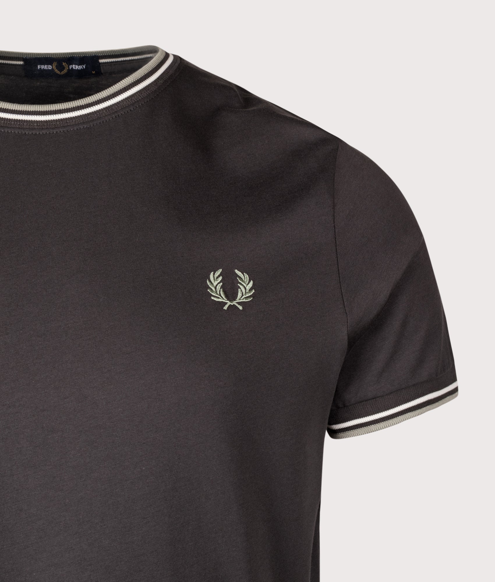 Fred Perry staple Twin Tipped T-Shirt in Anchor Grey, Ecru and Seagrass at EQVVS Menswear. Detail shot.