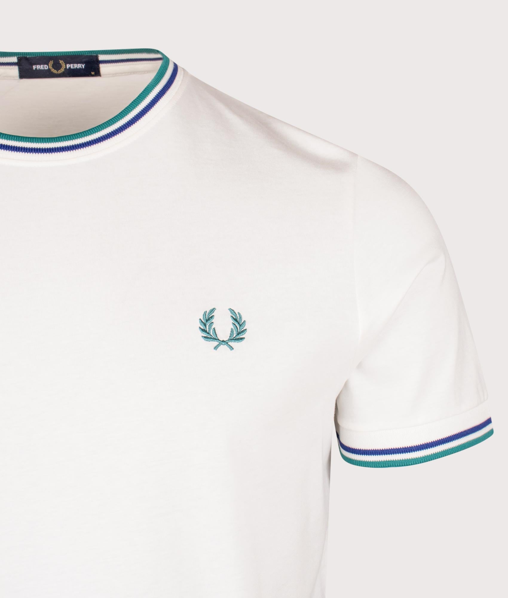 Fred Perry Twin Tipped T-Shirt in Snow White, Deep Mint and Soho Eclipse at EQVVS Menswear. Detail shot.