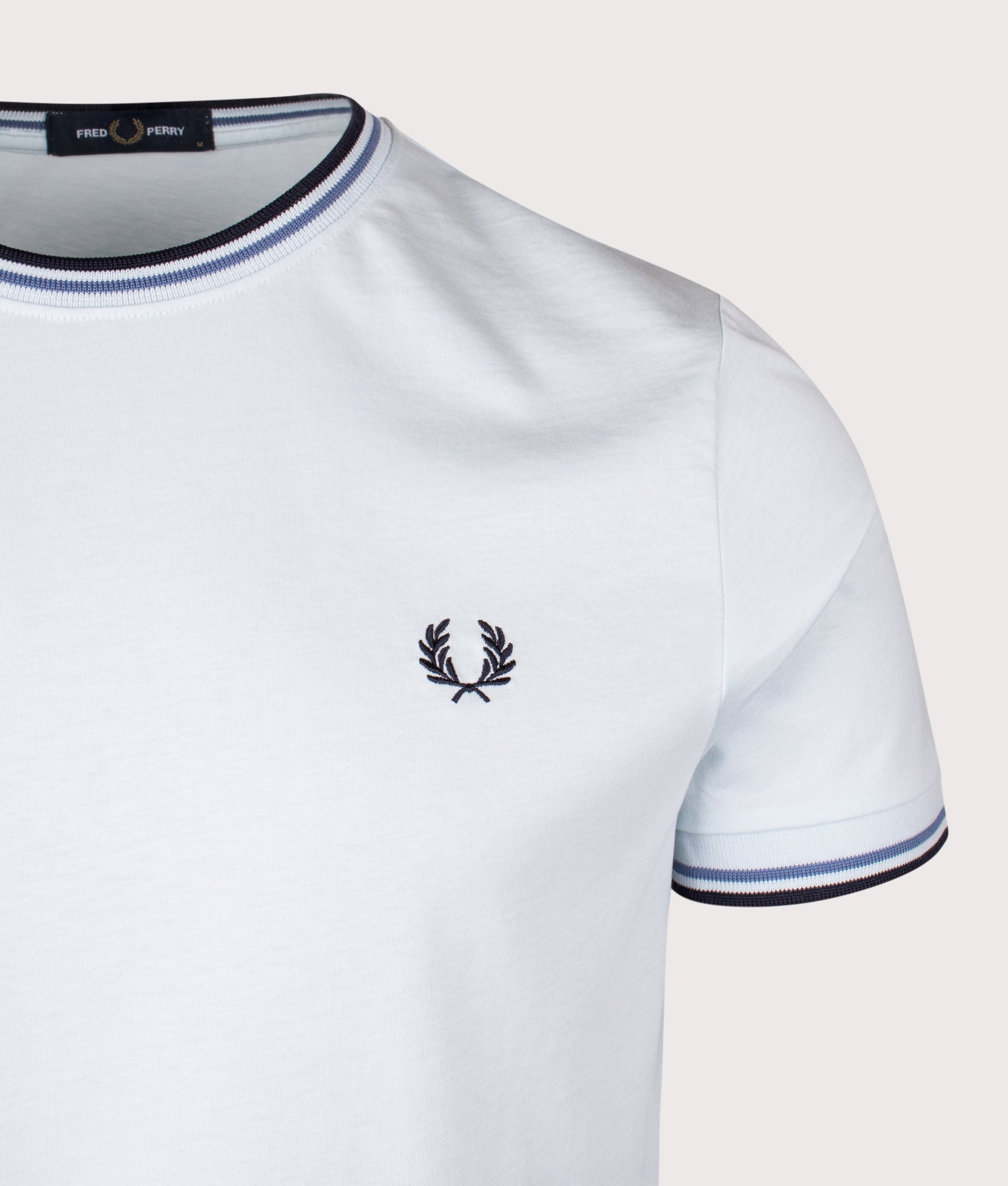 Fred Perry Twin Tipped T-shirt in Light Ice, Ace Blue and Navy at EQVVS Menswear. Detail shot.