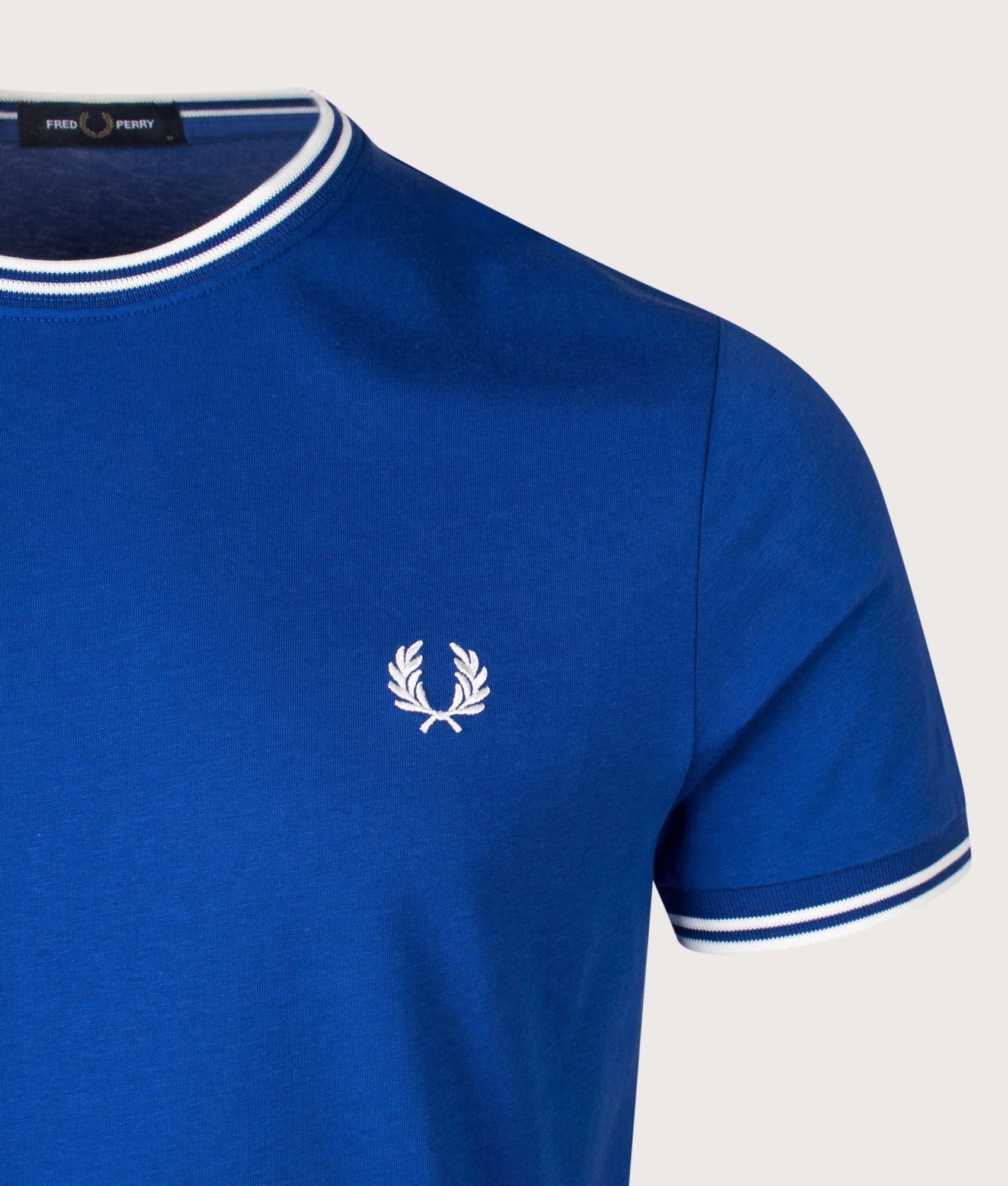 Fred Perry Twin Tipped T-Shirt in Soho Eclipse and Snow White at EQVVS Menswear. Detail shot.
