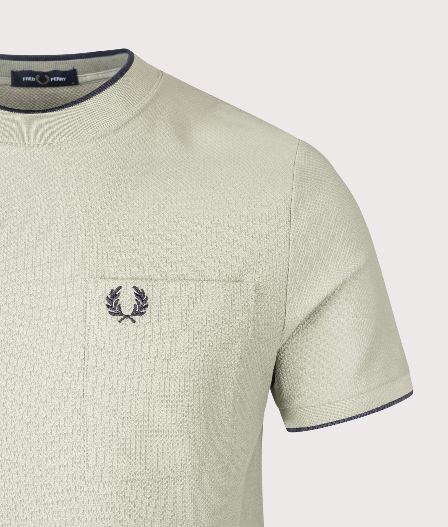 Fred Perry Pocket Detail Pique T-Shirt in Seagrass at EQVVS Menswear. Detail shot.
