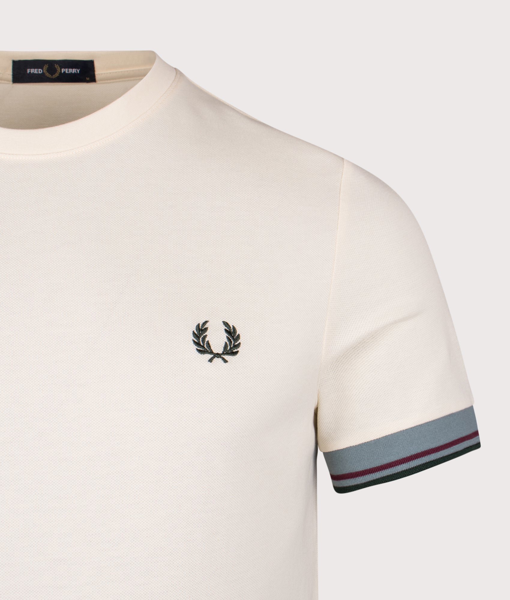 Fred Perry Twin Tipped Cuff T-Shirt in Ecru at EQVVS Menswear. Detail shot.