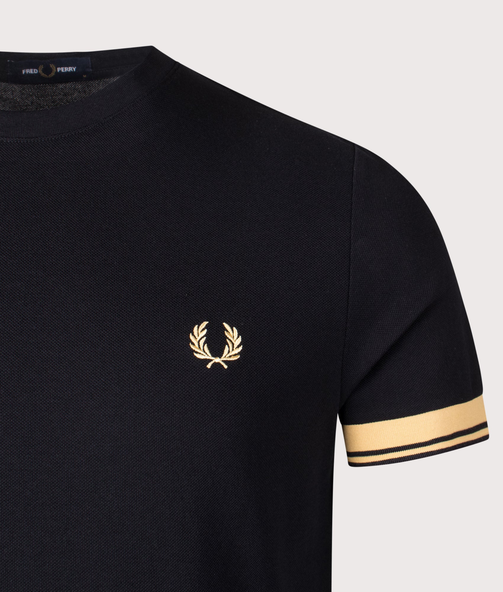 Fred Perry Twin Tipped Cuff T-Shirt in Champagne and Black at EQVVS Menswear. Detail shot.