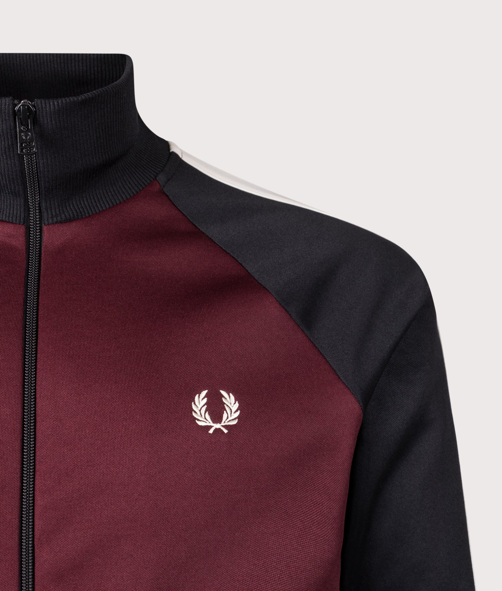Fred Perry Contrast Sleeve Track Jacket in Oxblood at EQVVS Menswear. Detail shot.