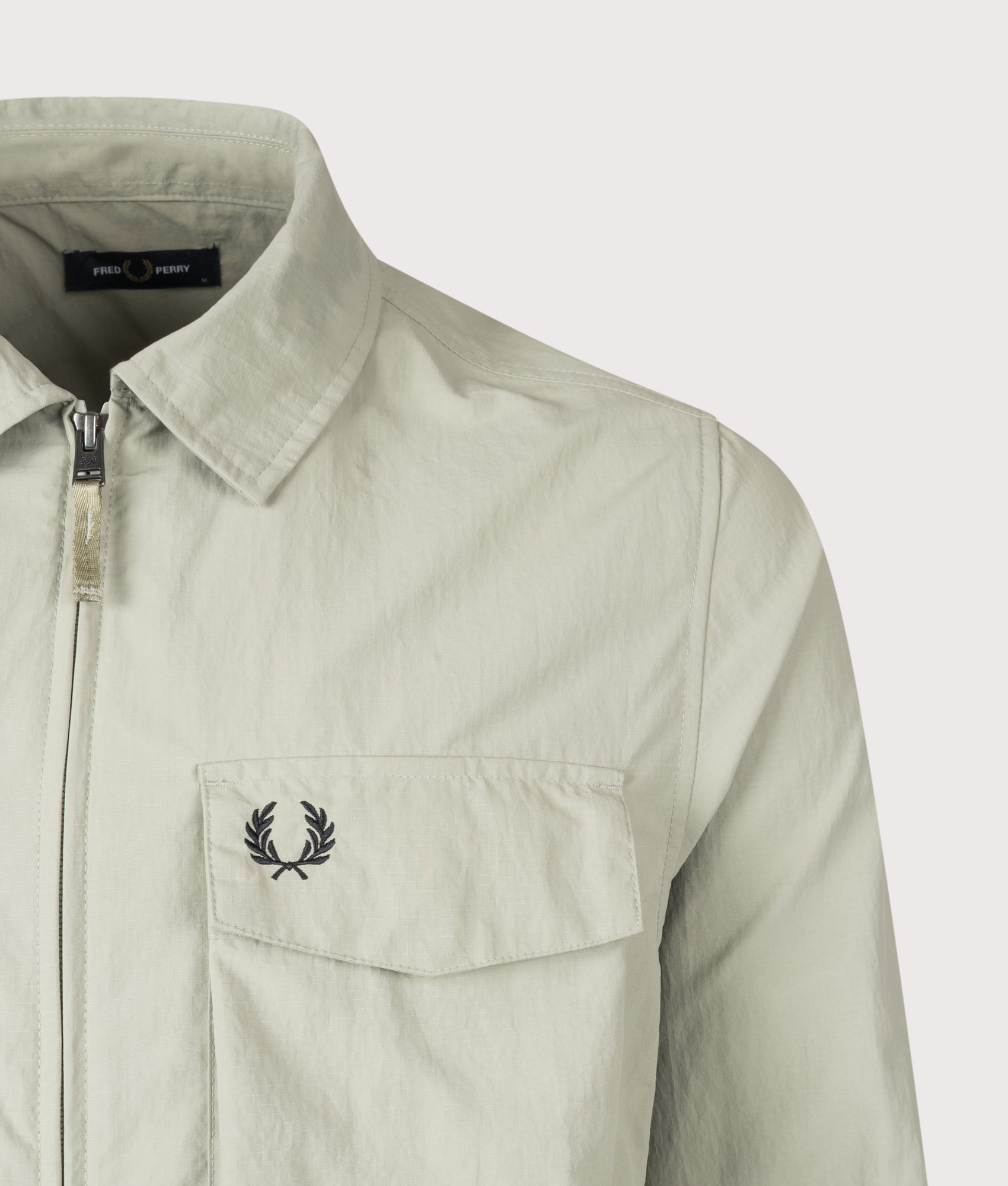 Fred Perry Ripstop Pocket Overshirt in Seagrass at EQVVS Menswear. Detail shot.