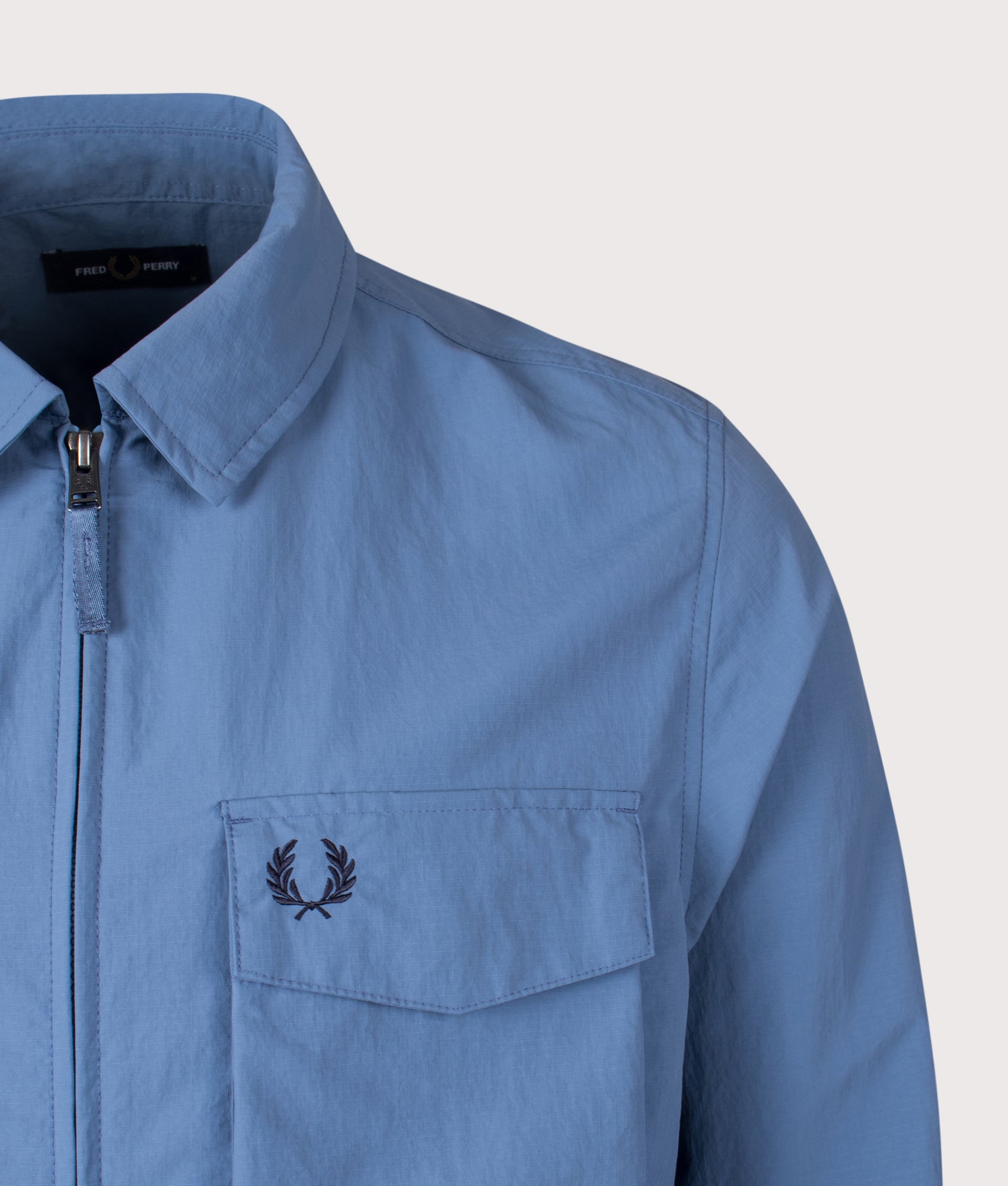 Fred Perry Ripstop Pocket Overshirt in Ace Blue at EQVVS Menswear. Detail shot.