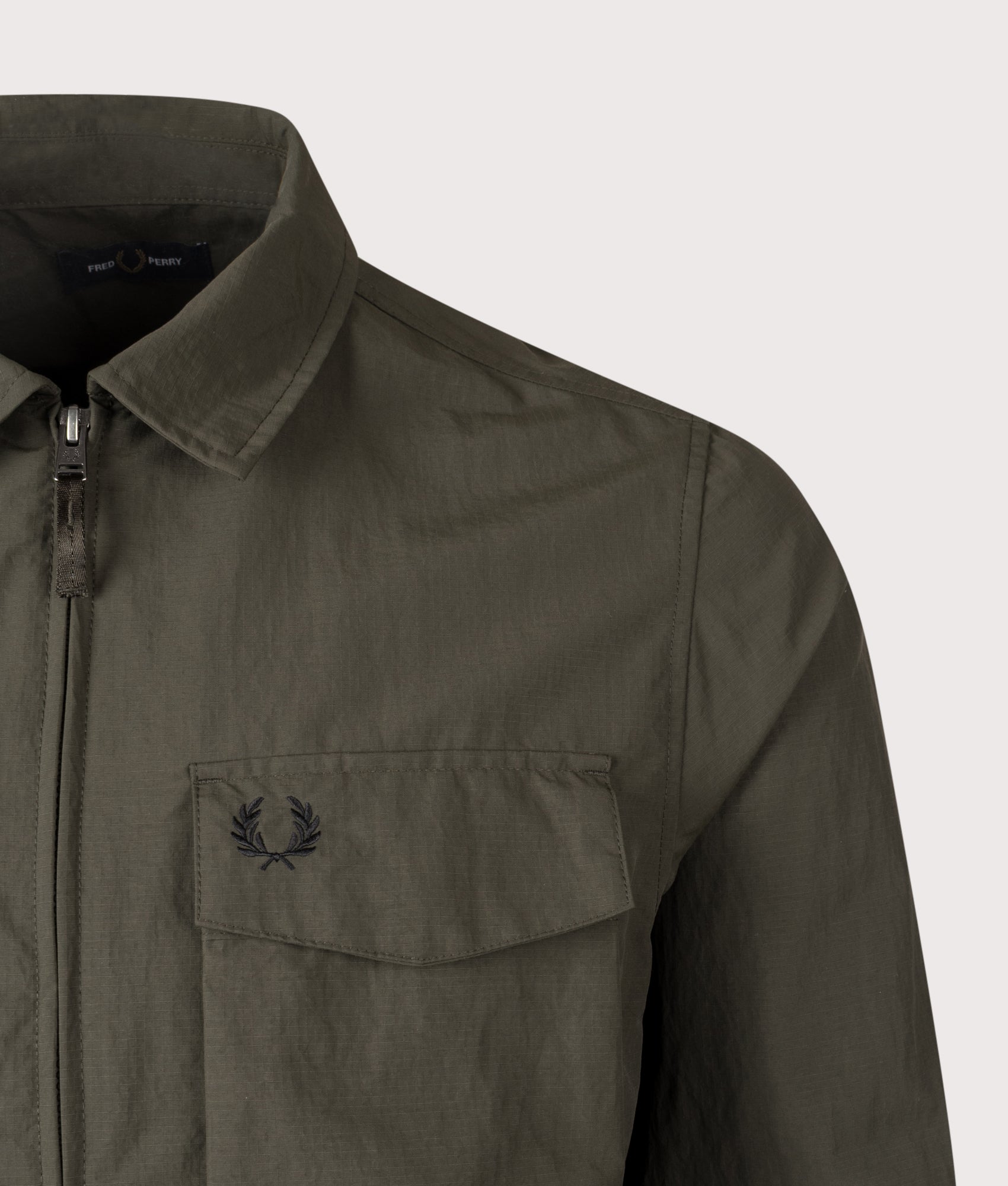 Fred Perry Ripstop Pocket Overshirt in Hunting Green at EQVVS Menswear. Detail Shot.