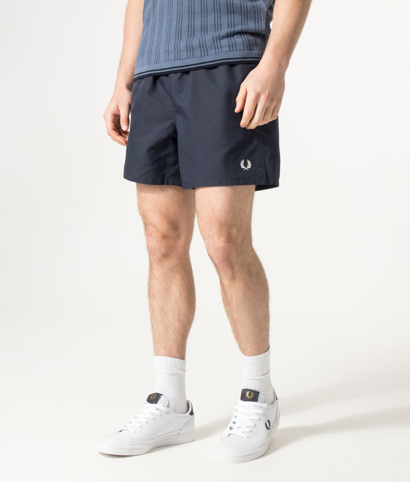 Fred Perry Swimshorts in Navy at EQVVS Menswear. Angled model front shot.