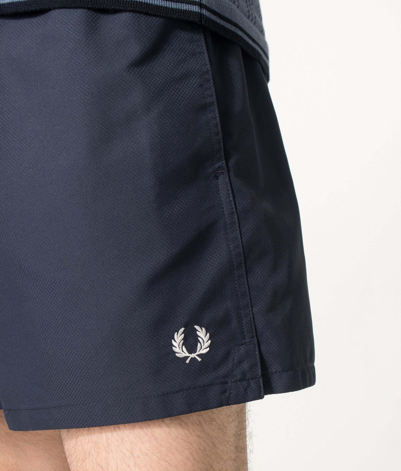 Fred Perry Swimshorts in Navy at EQVVS Menswear. Detail shot.