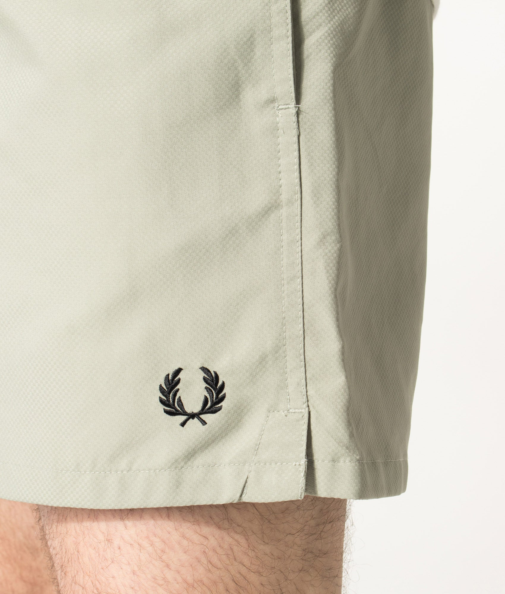 Fred Perry Swimshorts in Seagrass at EQVVS Menswear. Detail shot.