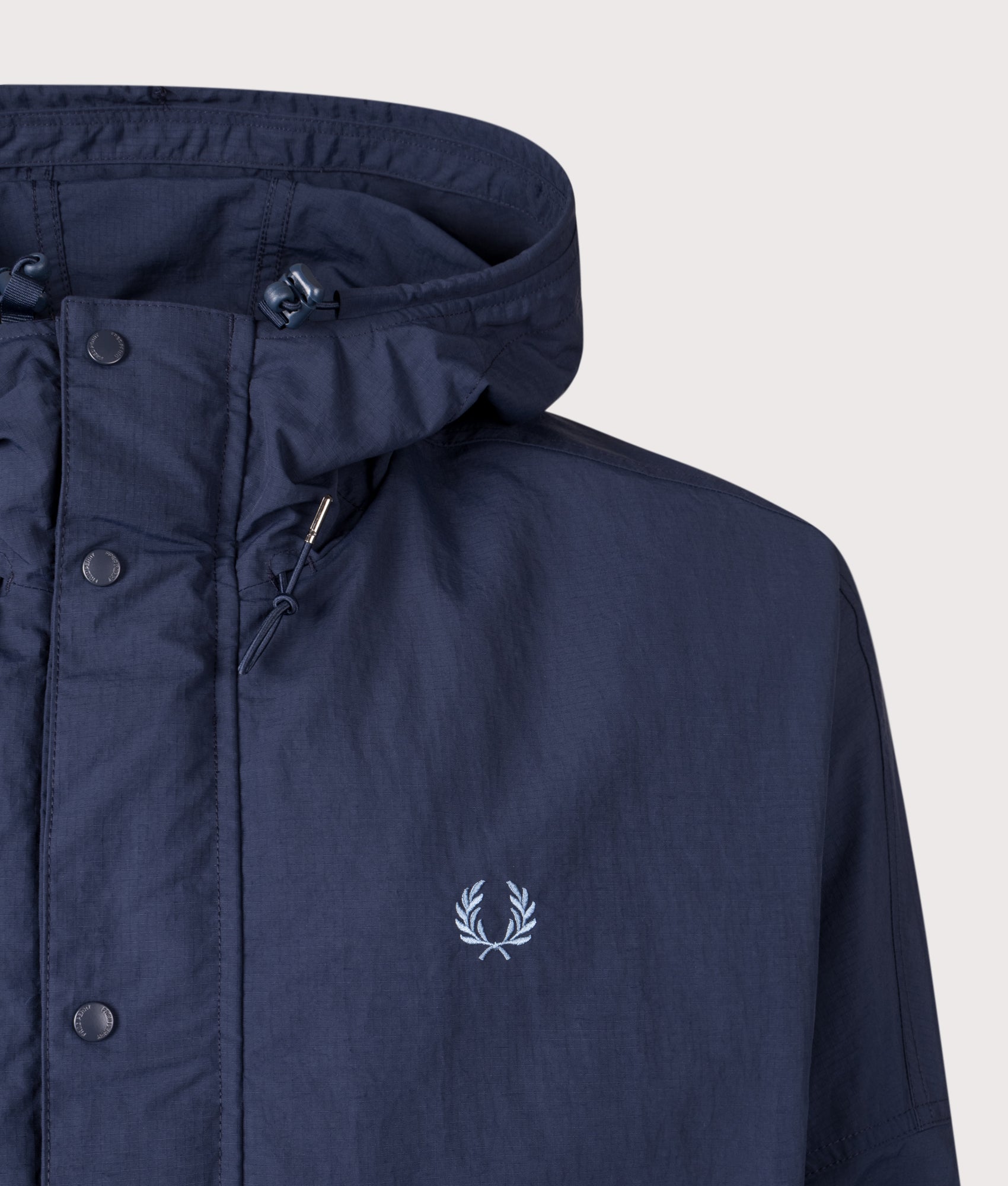 Fred Perry Cropped Ripstop Parka in Tennis Blue at EQVVS Menswear. Detail shot.