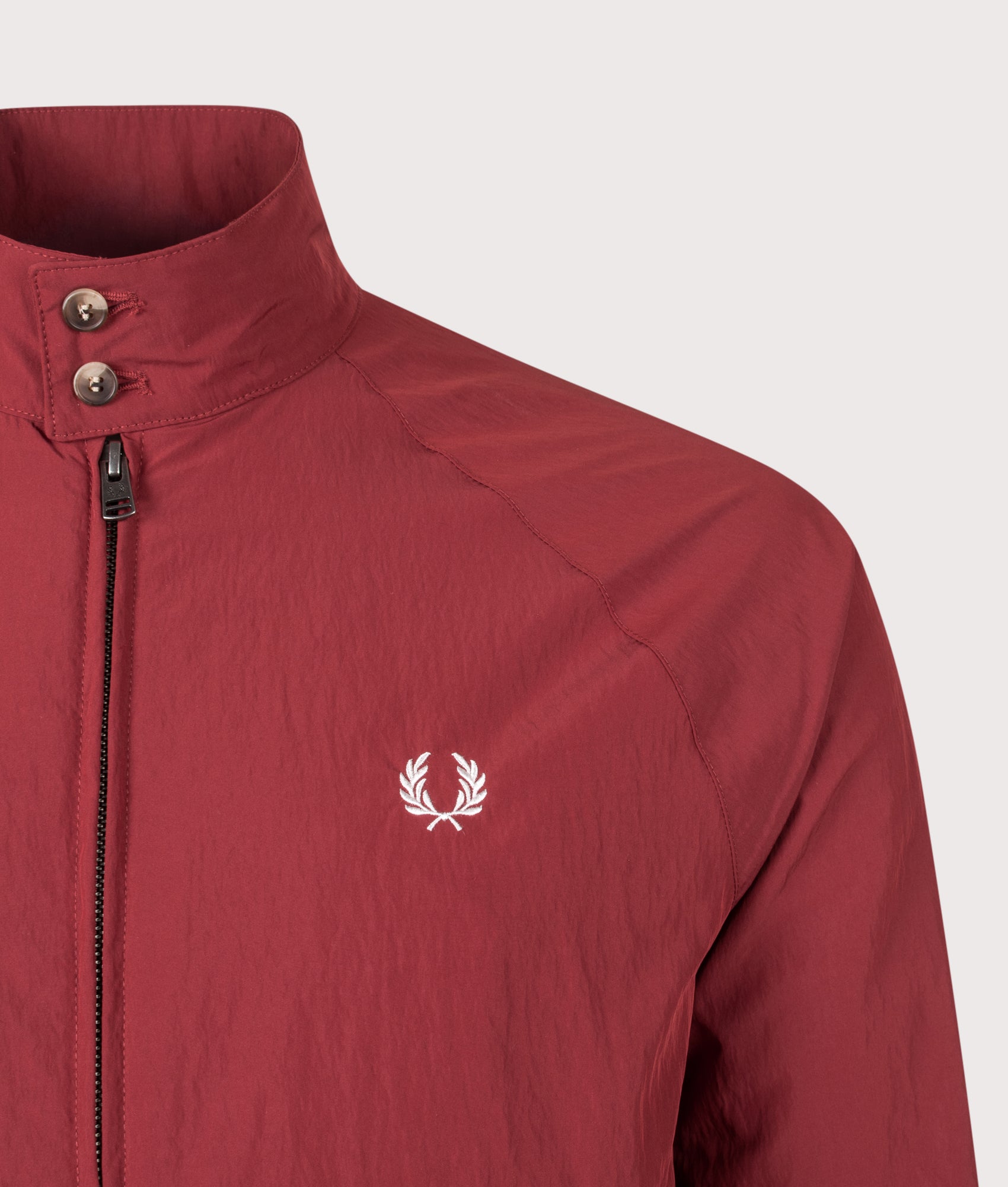 Fred Perry Crinkle Harrington Jacket in Burnt Red at EQVVS Menswear. Detail shot.