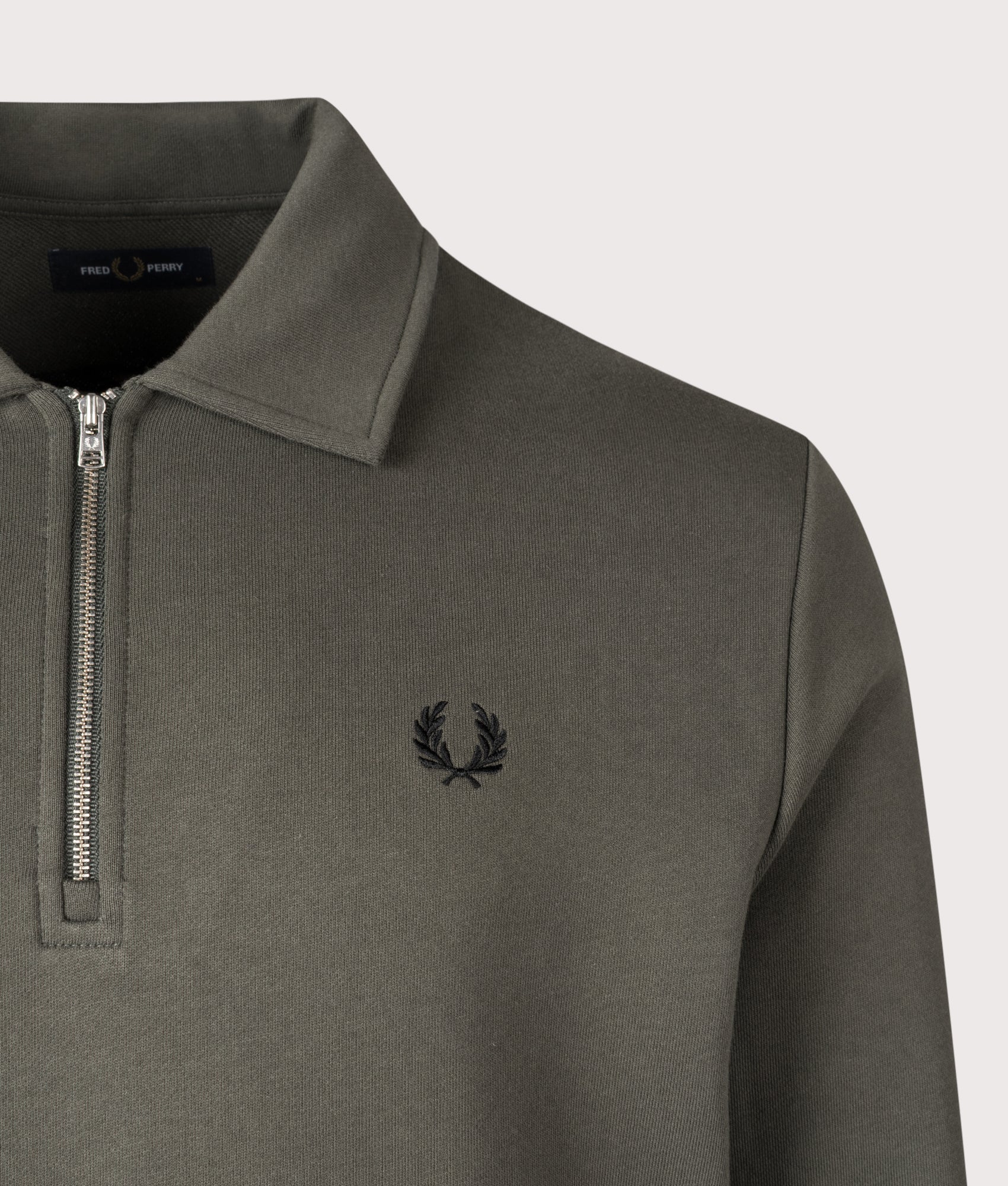 Fred Perry Quarter Zip Collared Sweatshirt in Field Green at EQVVS Menswear. Detail shot.