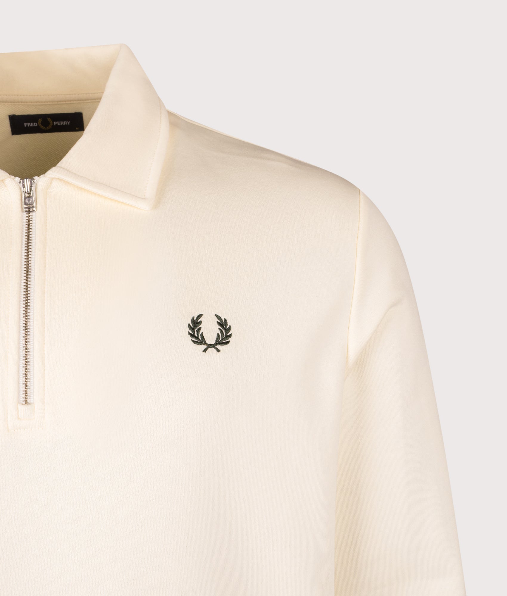 Fred Perry Quarter Zip Collared Sweatshirt in Ecru at EQVVS Menswear. Detail shot.