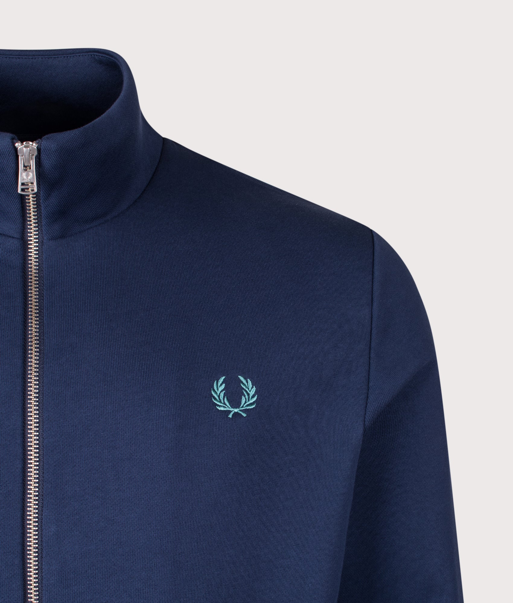 Fred Perry Zip Through Sweatshirt in Tennis Blue at EQVVS Menswear. Detail shot.