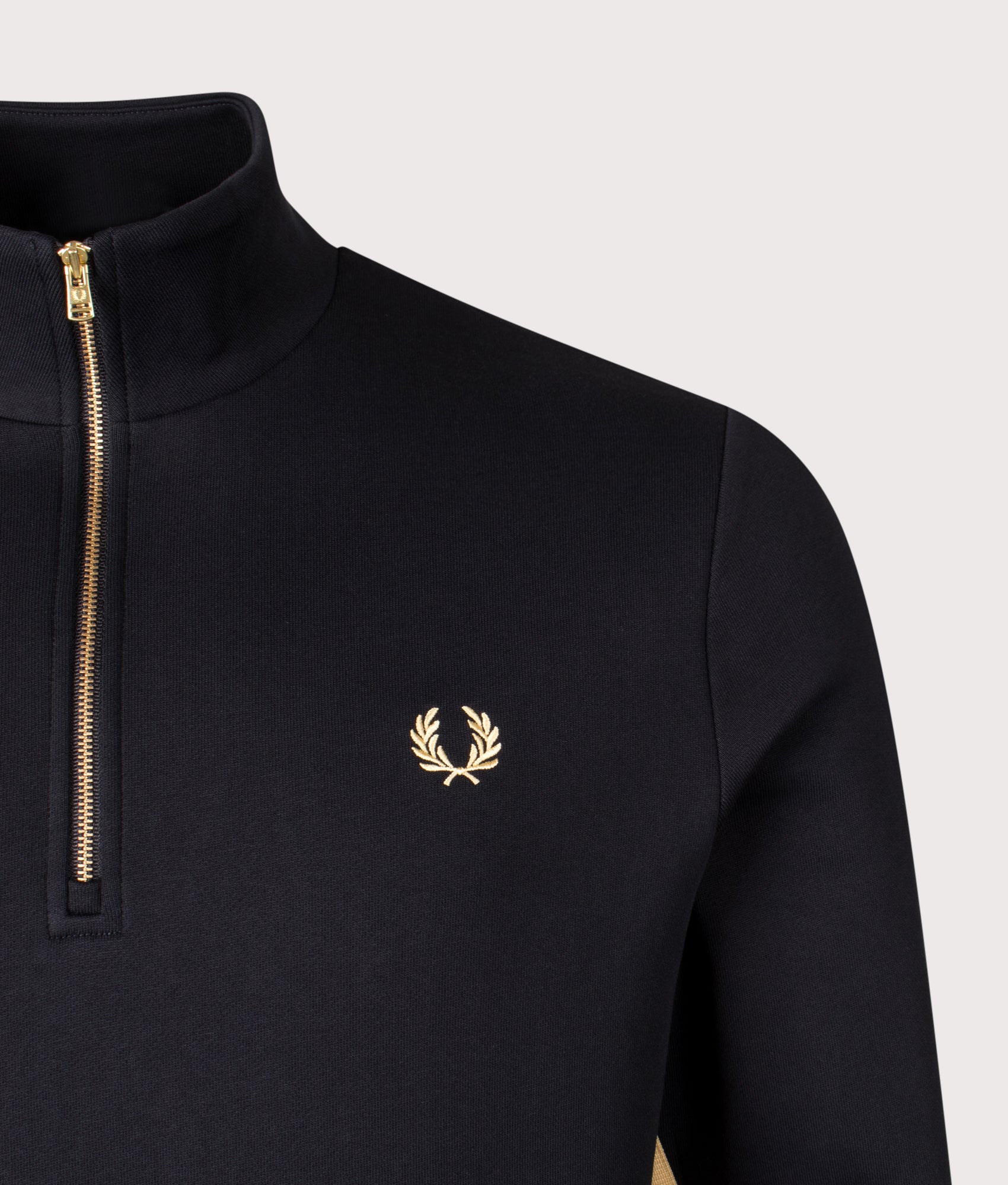 Fred Perry Stripe Tape Quarter Zip Sweatshirt in Black and Champagne at EQVVS Menswear. Detail shot.