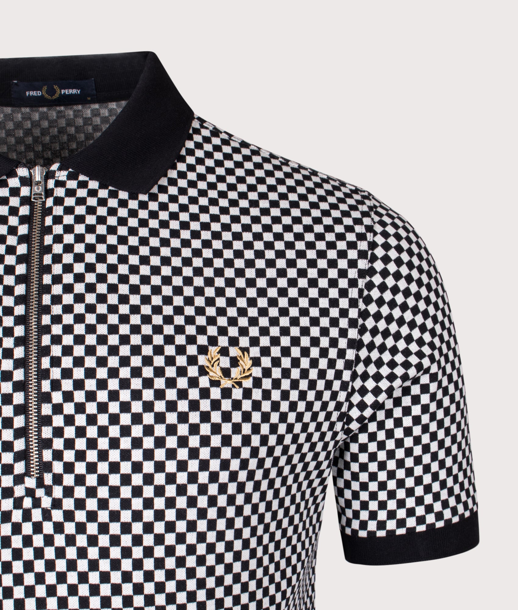 Fred Perry Chequerboard Zip Neck Polo Shirt in Black at EQVVS Menswear. Detail shot.
