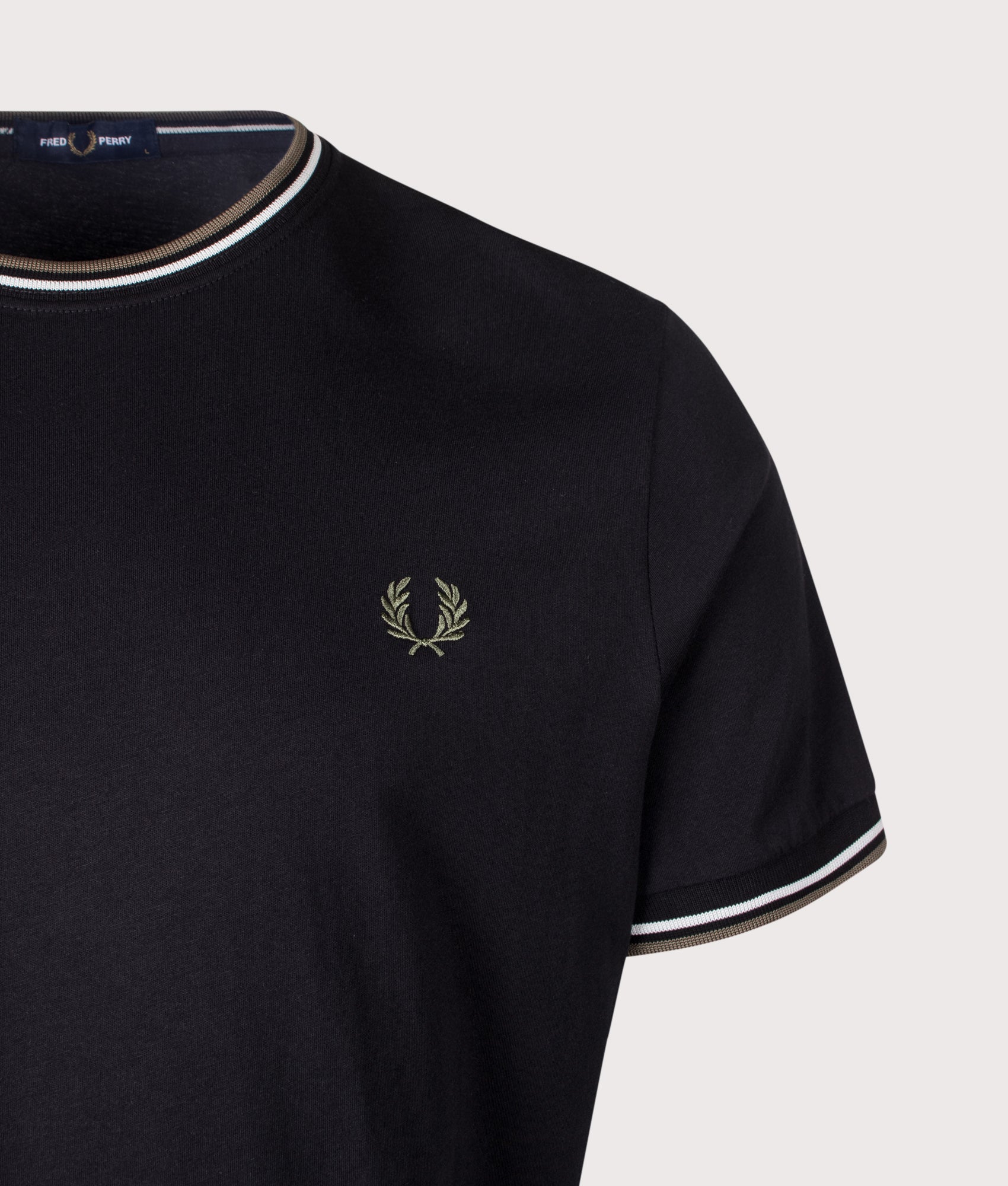 Fred Perry Twin Tipped T-Shirt in Black, Ecru and Laurel Wreath Green at EQVVS Menswear. Detail shot.
